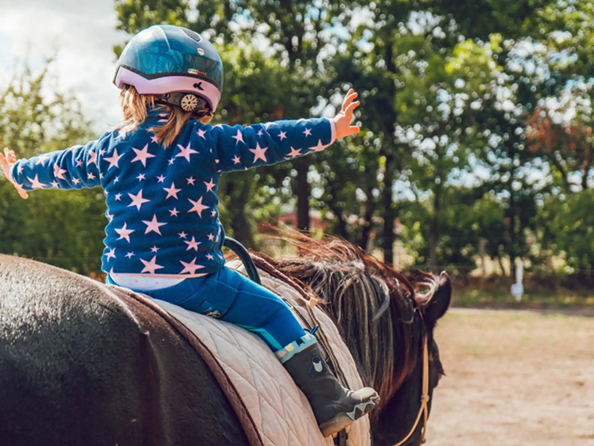 a girl riding a horse