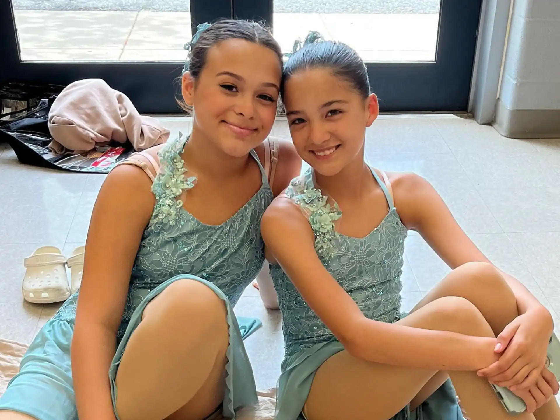 two girls sitting on the floor