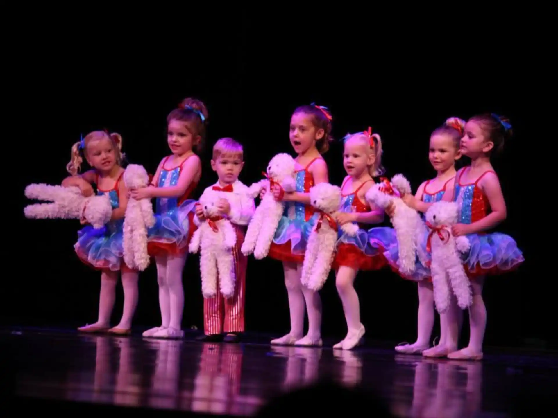 a group of girls in matching outfits