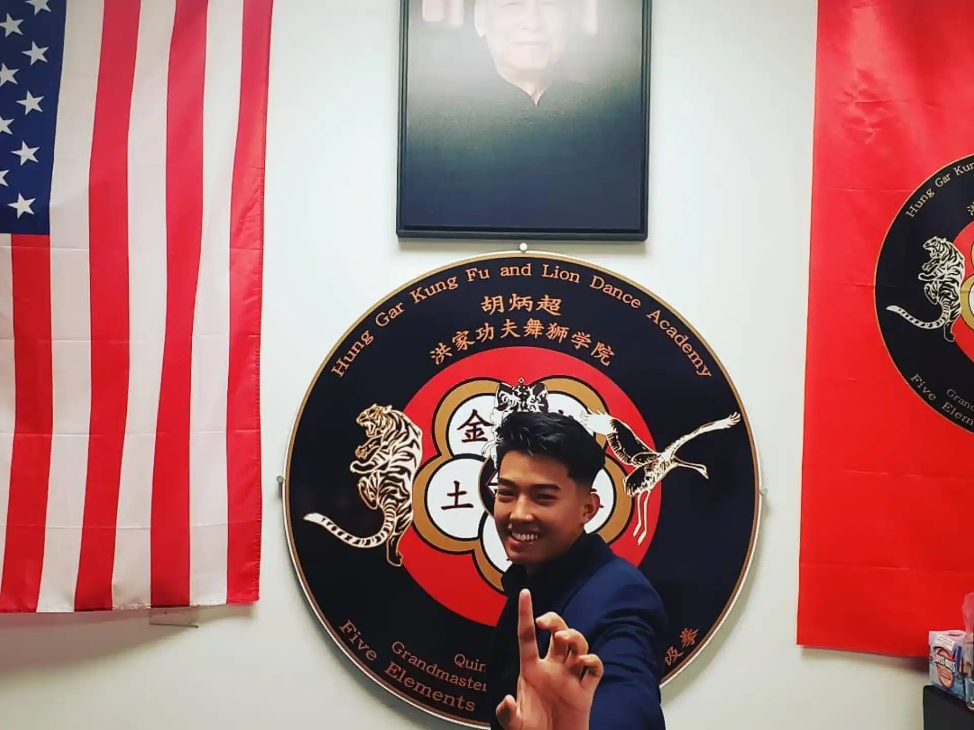 a person standing in front of a flag with a picture of a person
