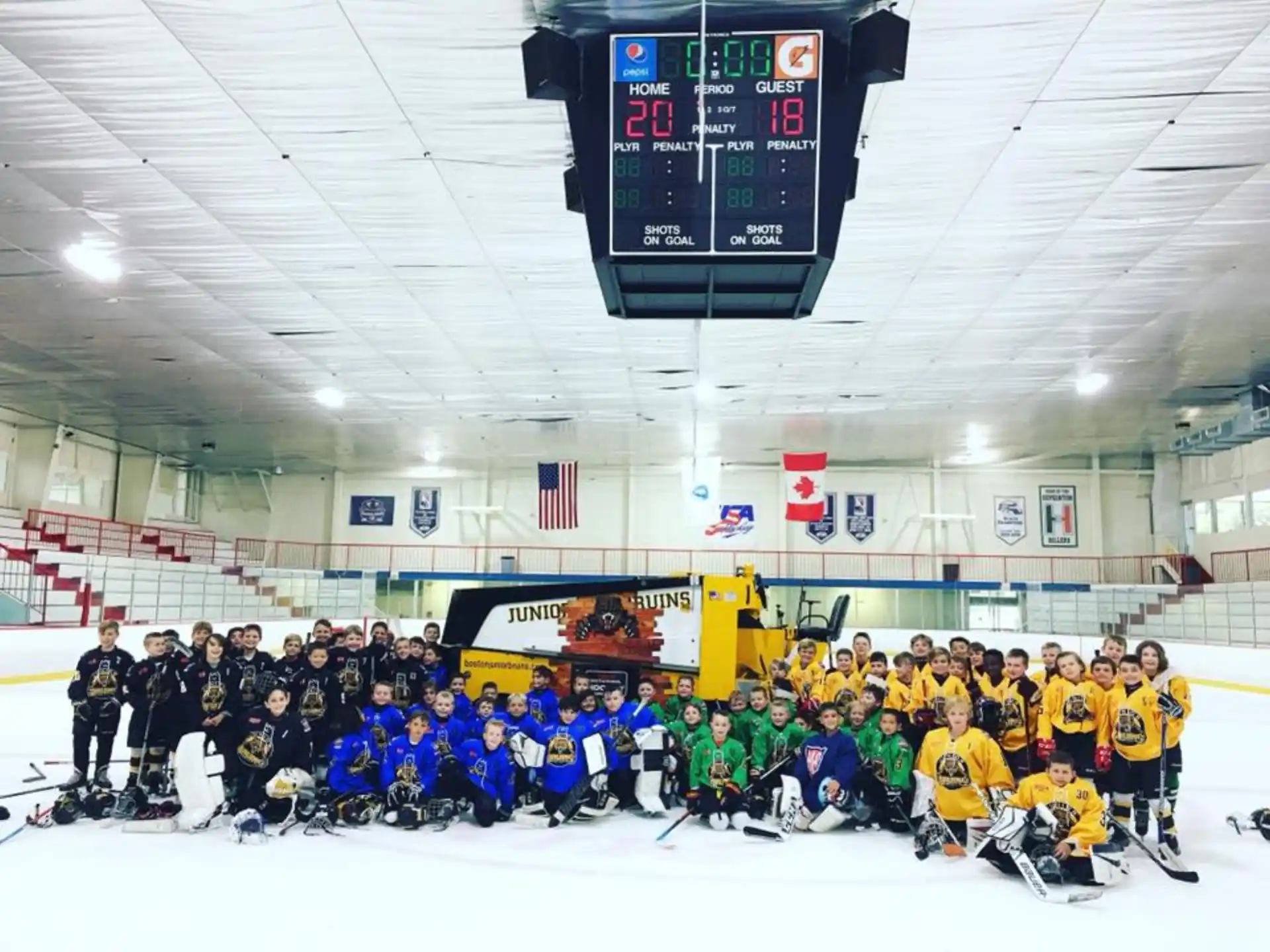 a group of people posing for a photo in a hockey rink