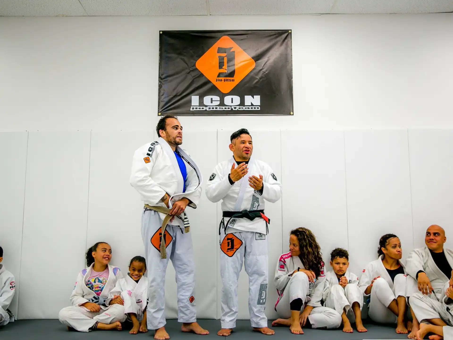 a group of people in white karate uniforms
