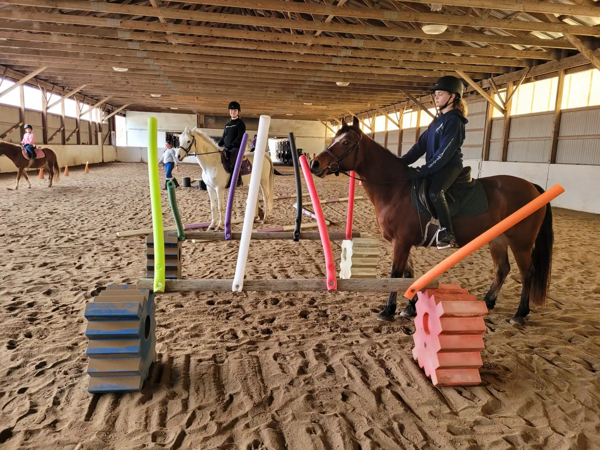 a person riding a horse in a stable