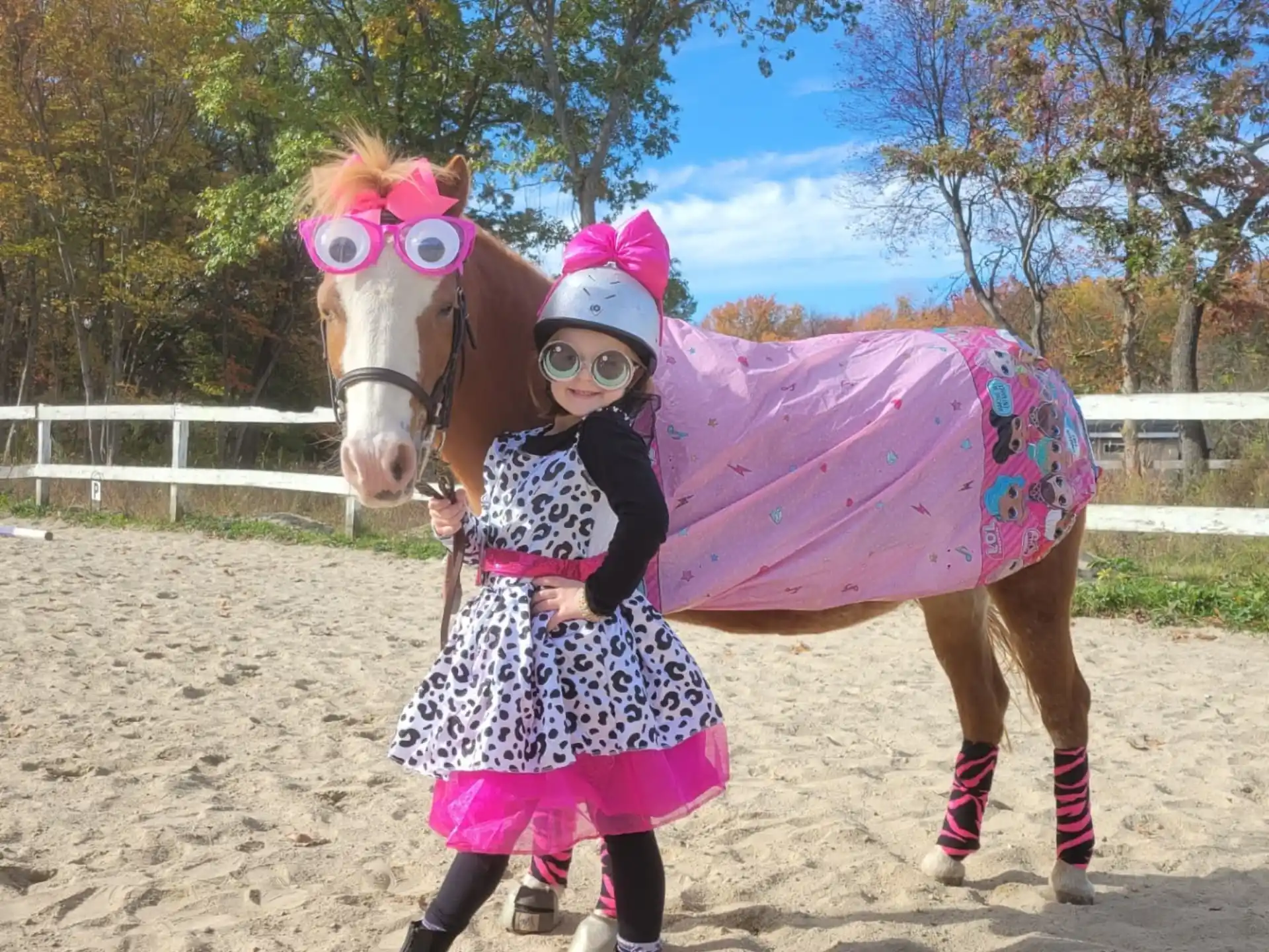 a person wearing a garment and standing next to a horse