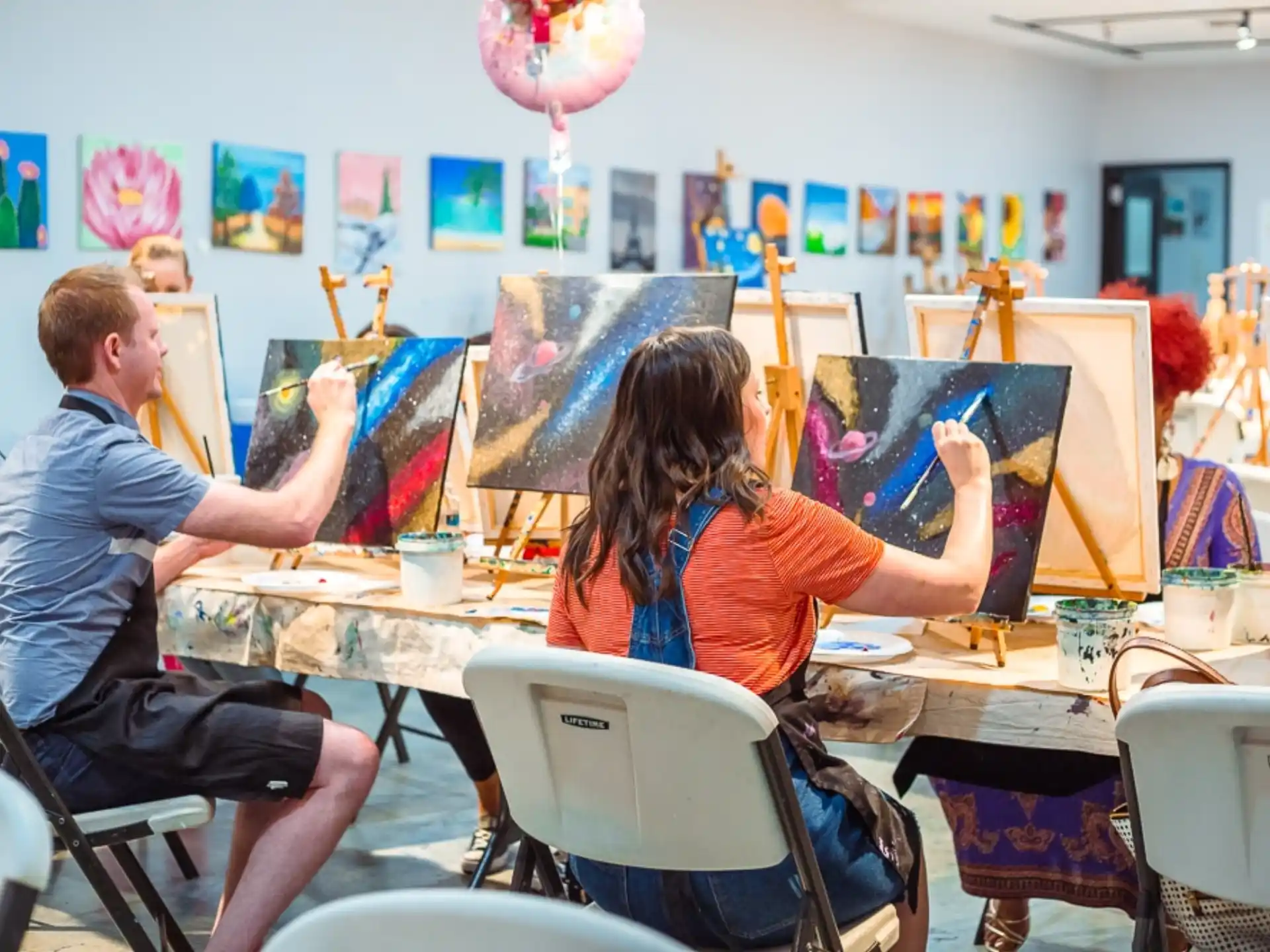 a man and woman painting
