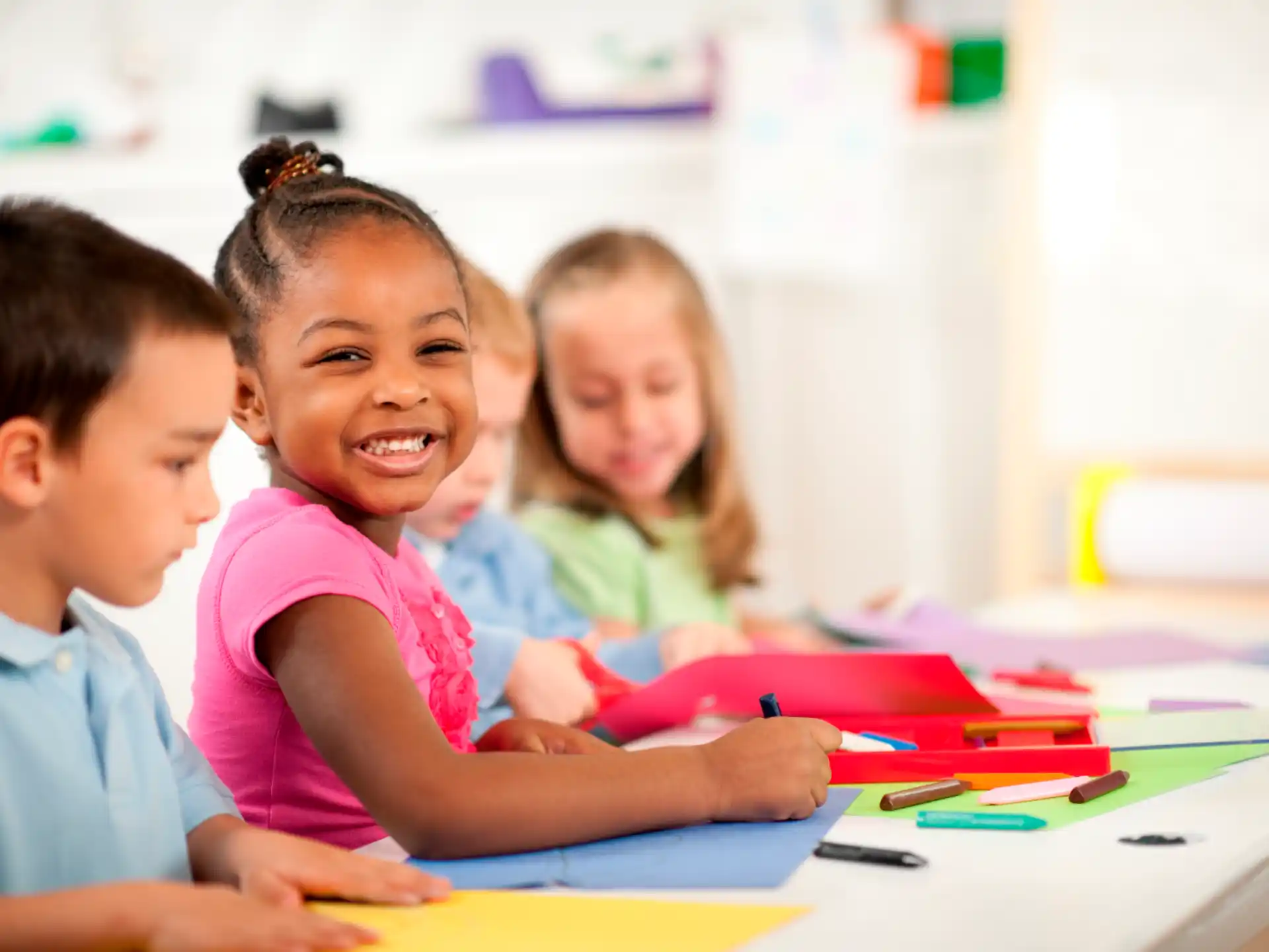 a group of children sitting at a table