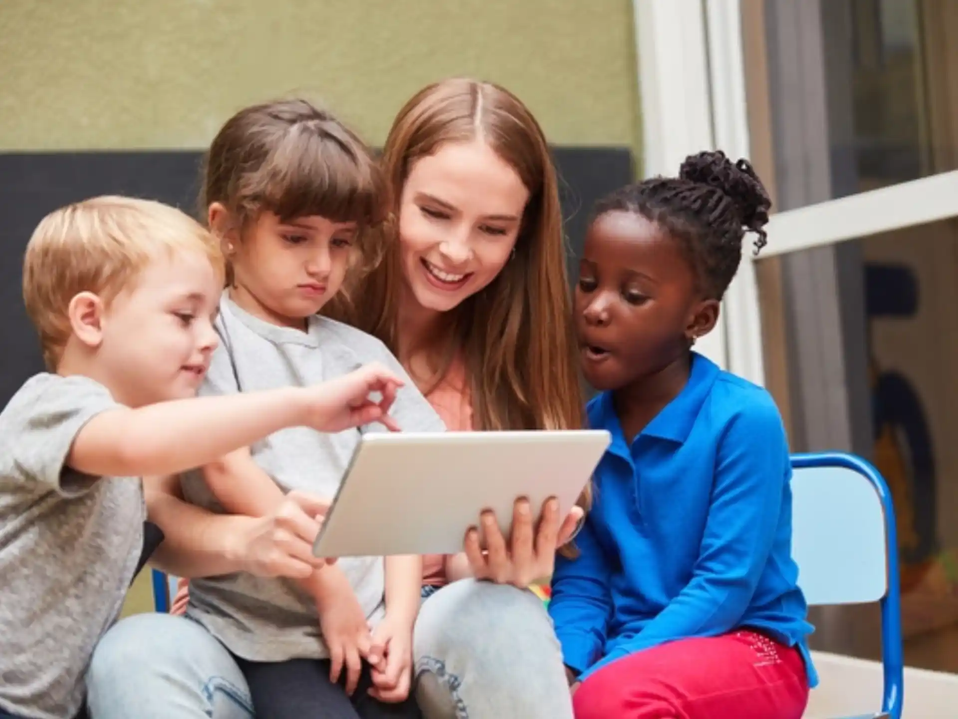 a person reading a book to a group of children