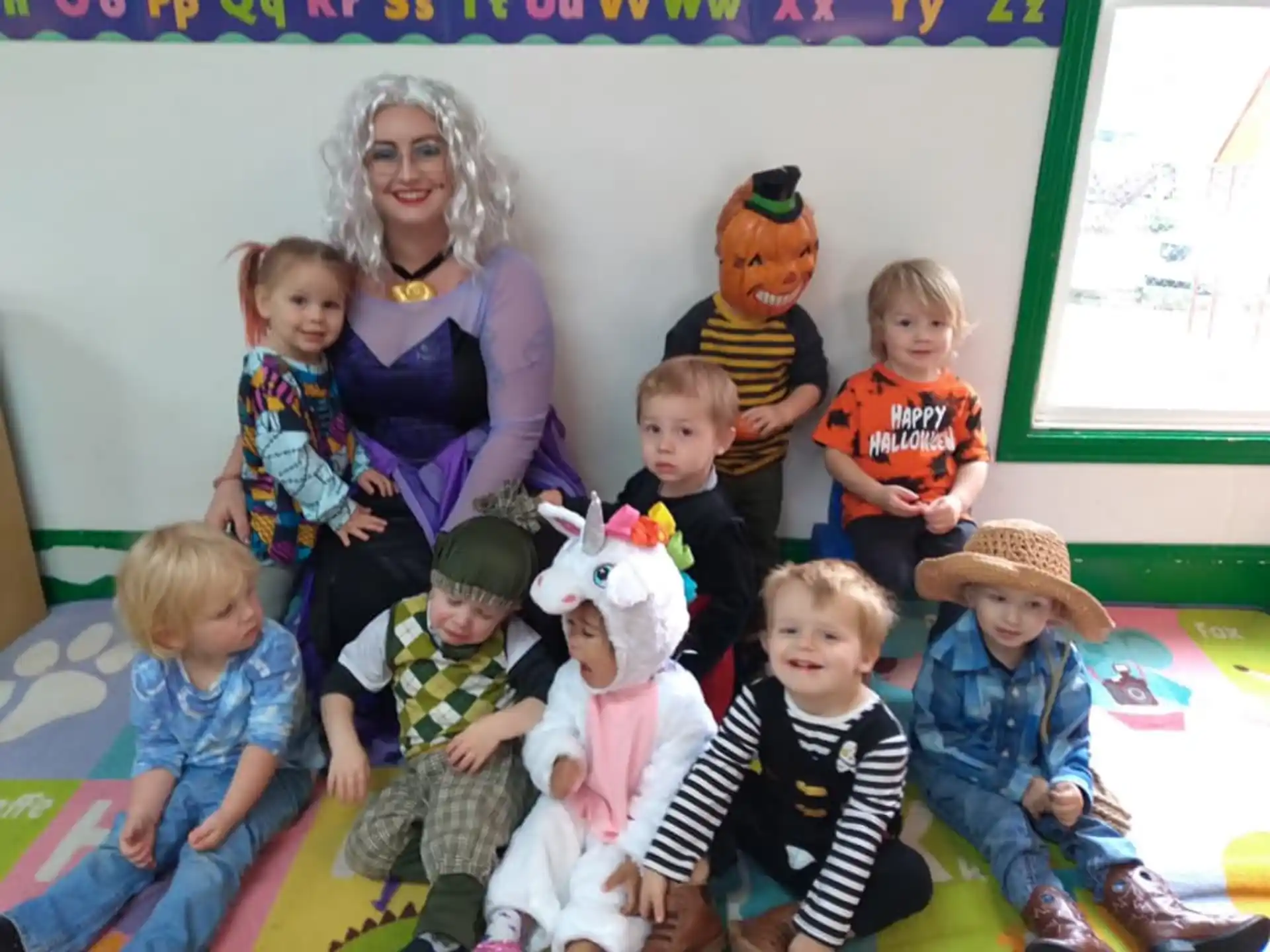 a group of children and a person with a group of children