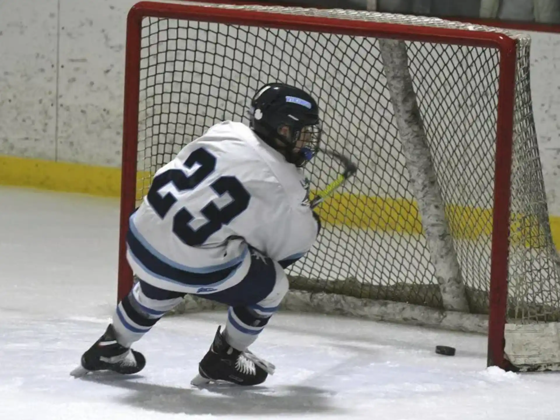 a hockey player in a white uniform