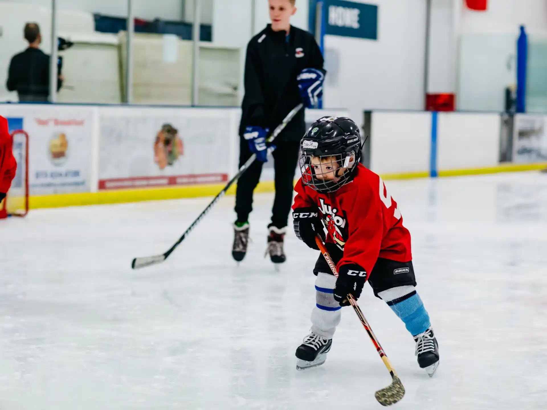 a person wearing a hockey uniform and holding a hockey stick