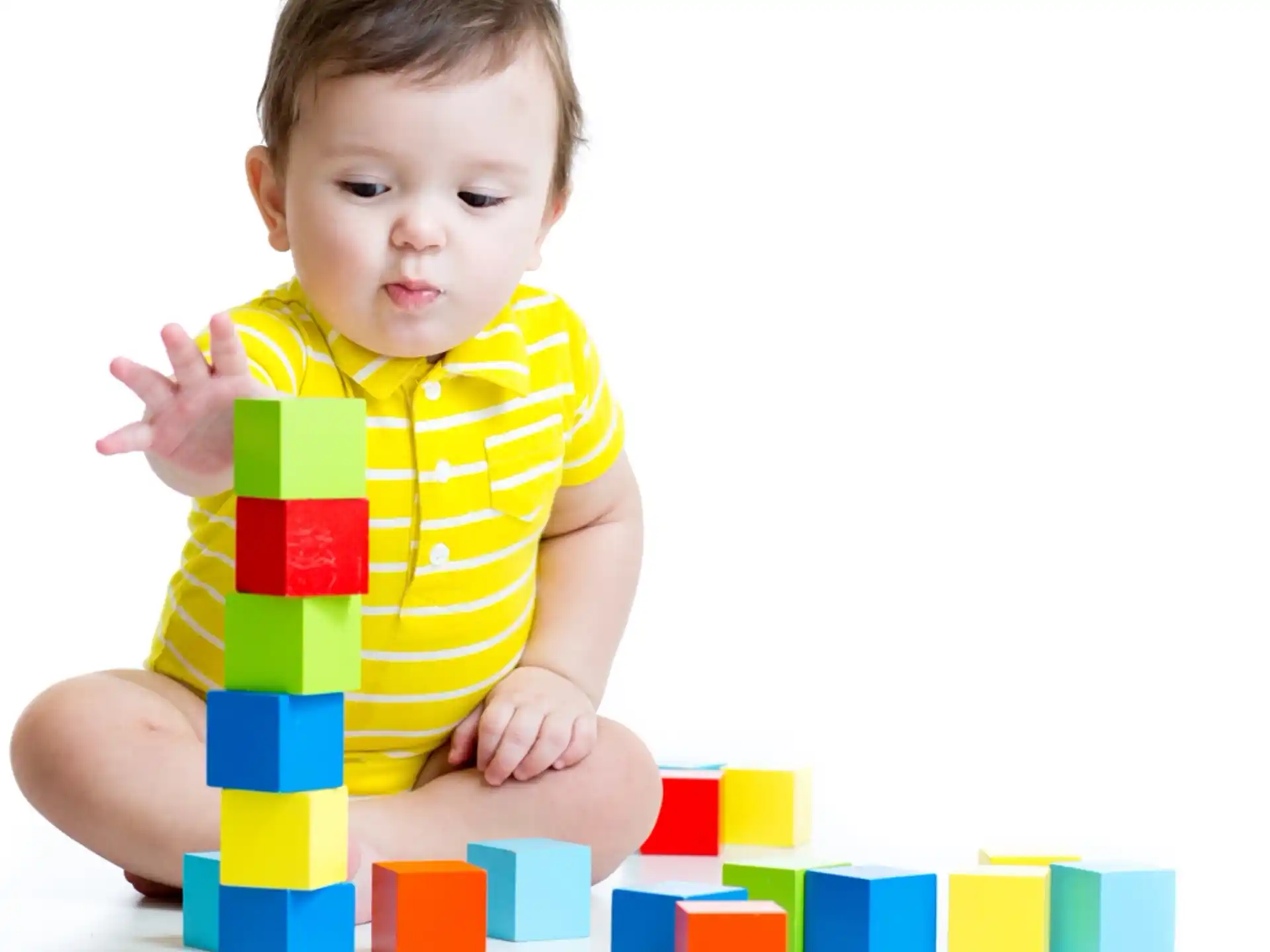 a baby sitting on a pile of blocks