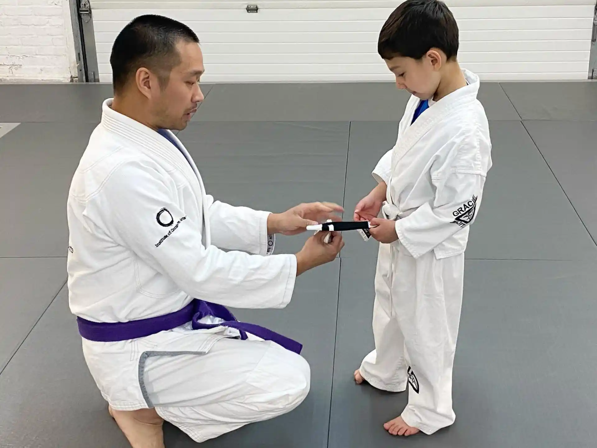 a man and a boy in karate uniforms