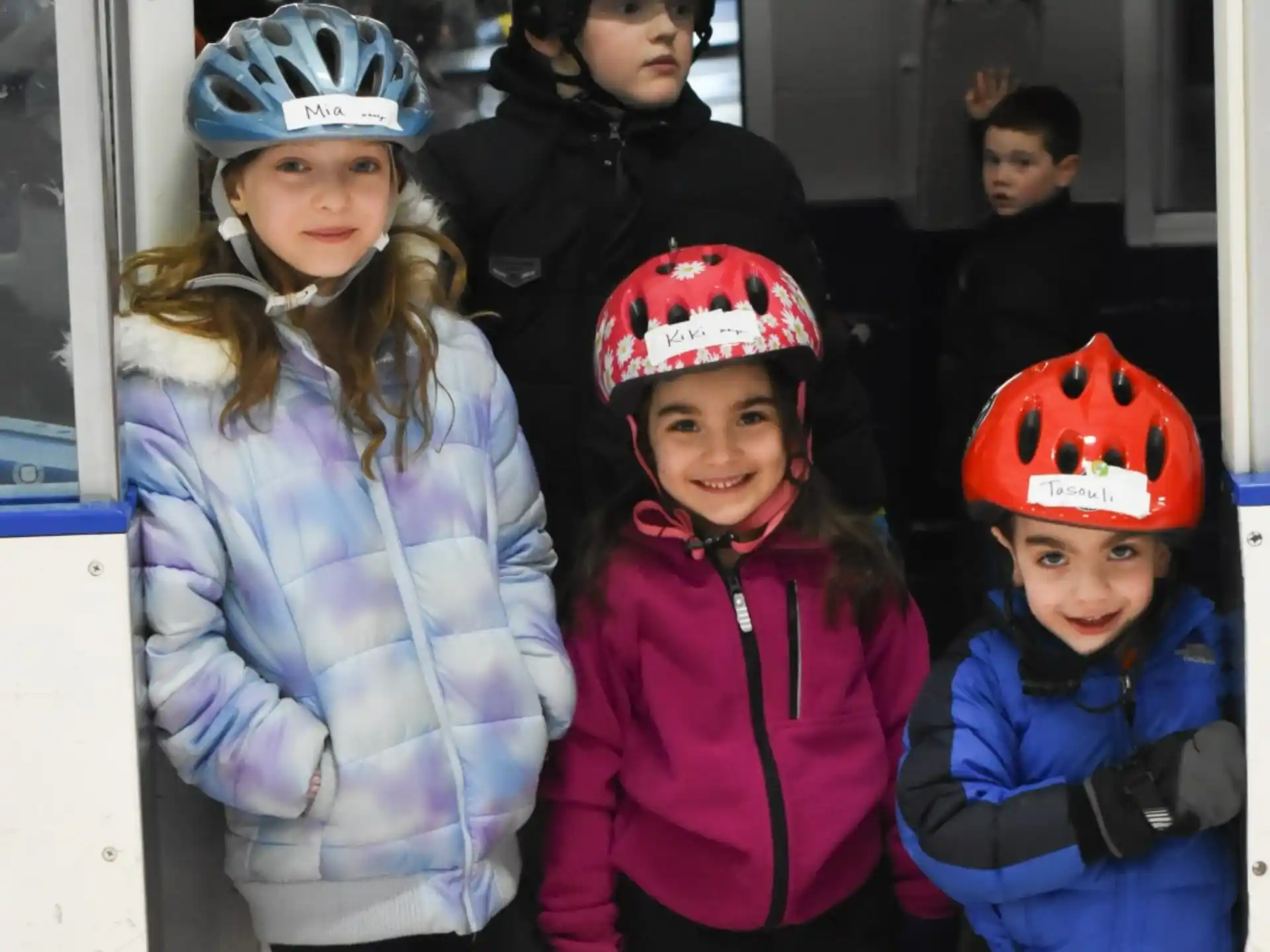 a group of children wearing helmets