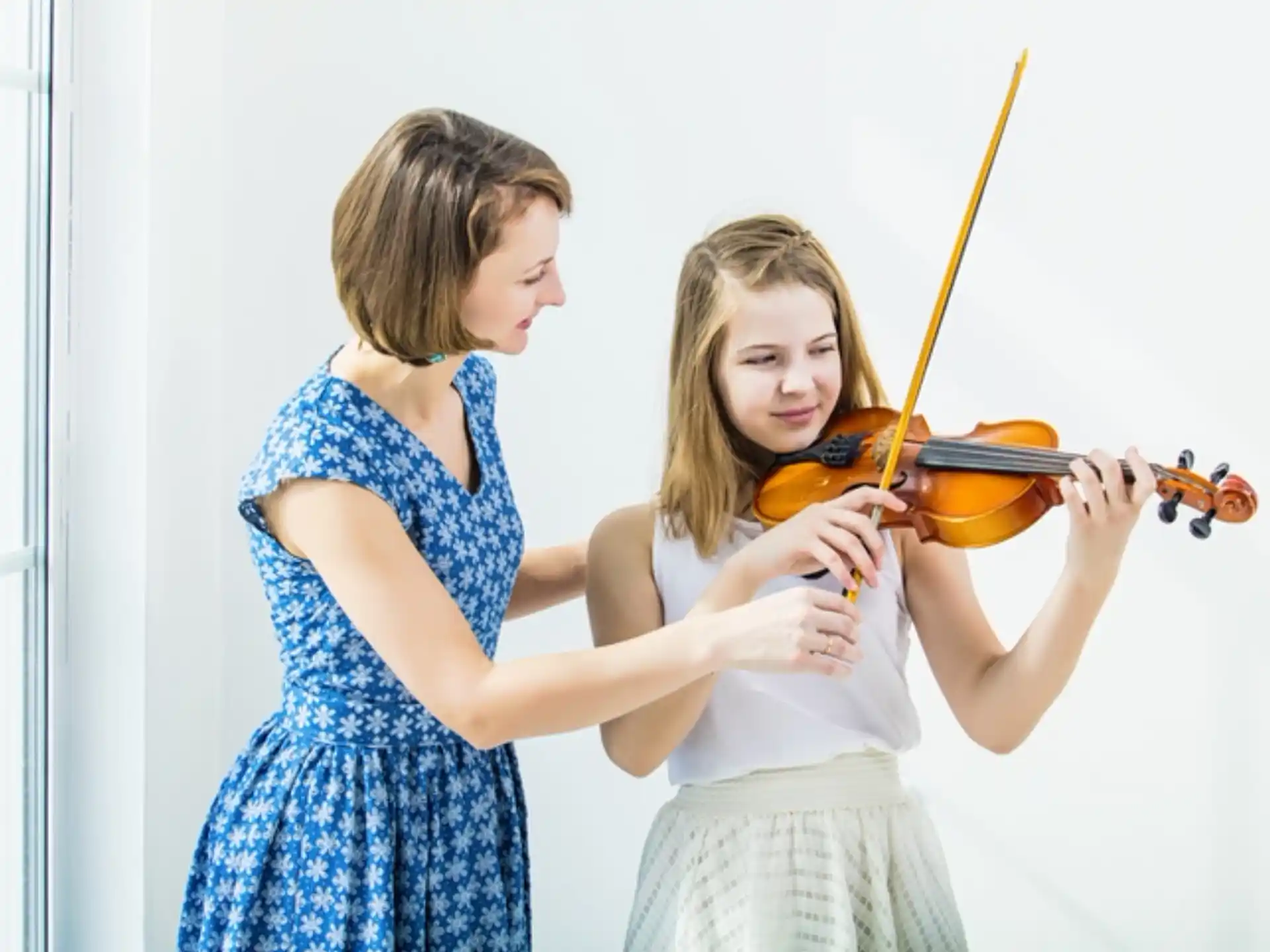 a couple of girls playing violin