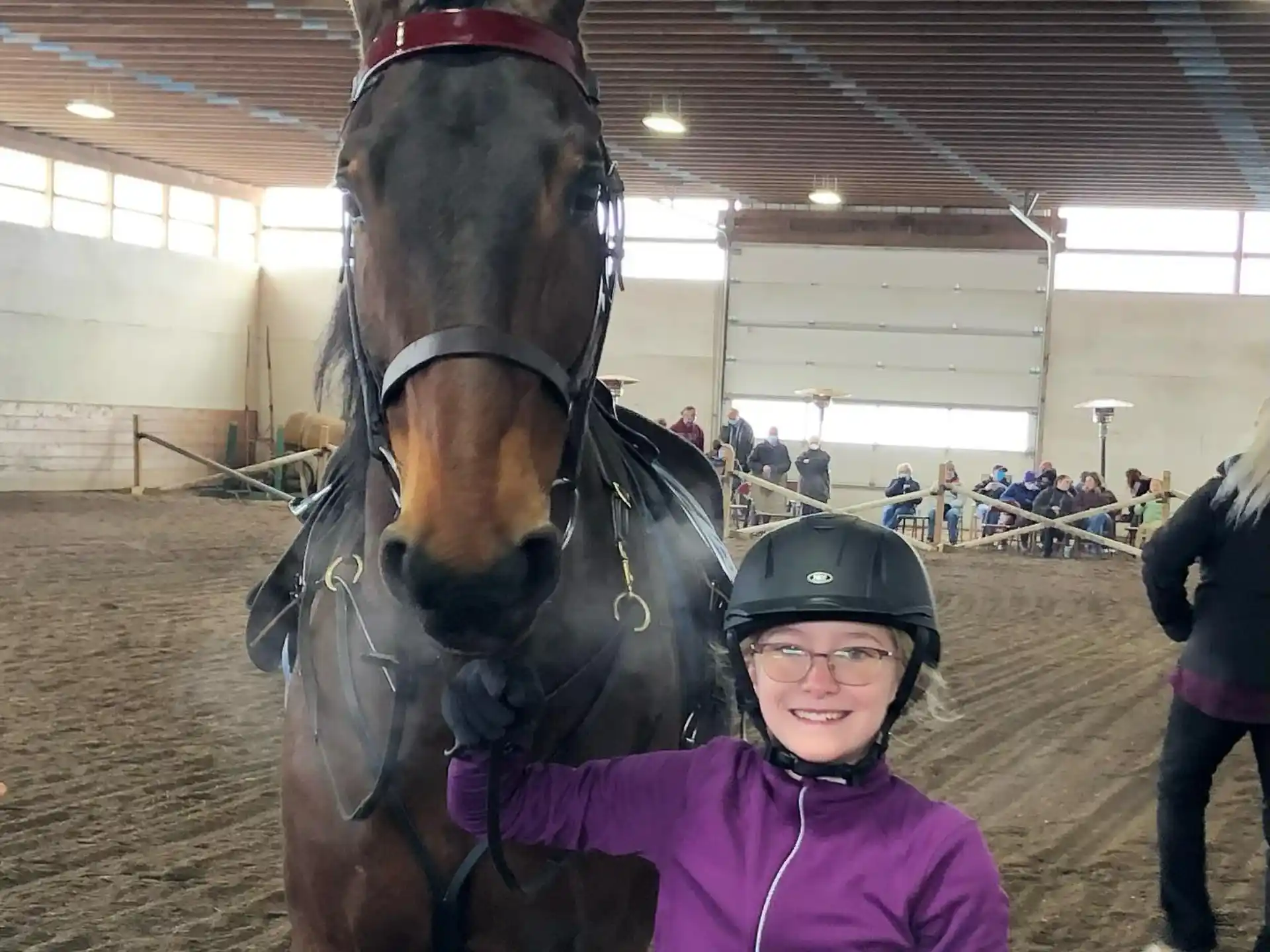 a person standing next to a horse