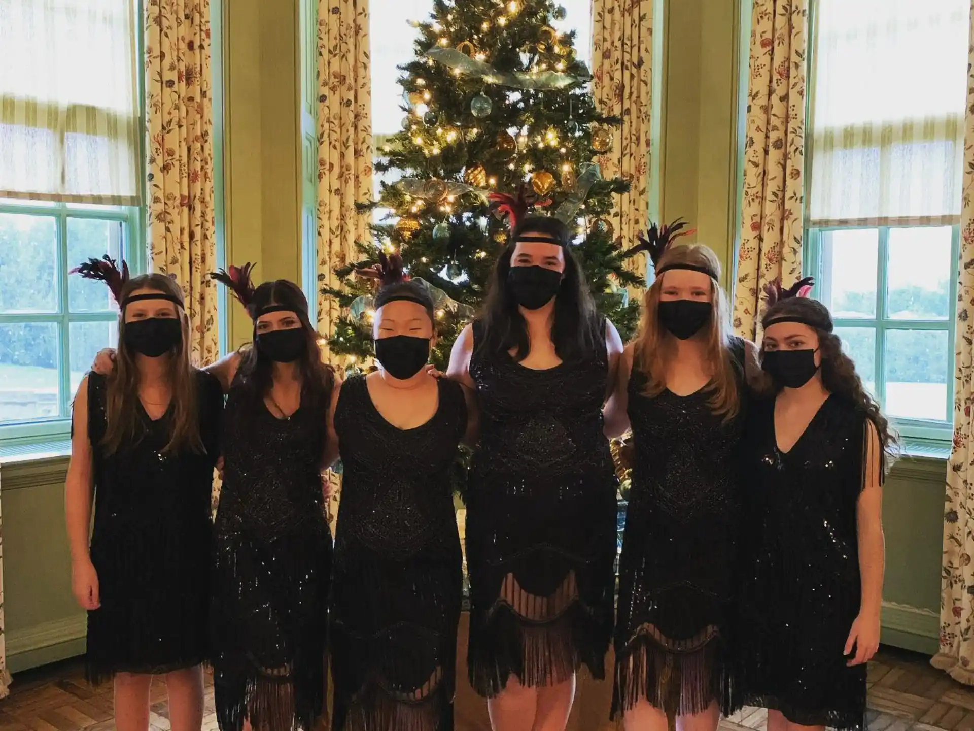 a group of women in black dresses