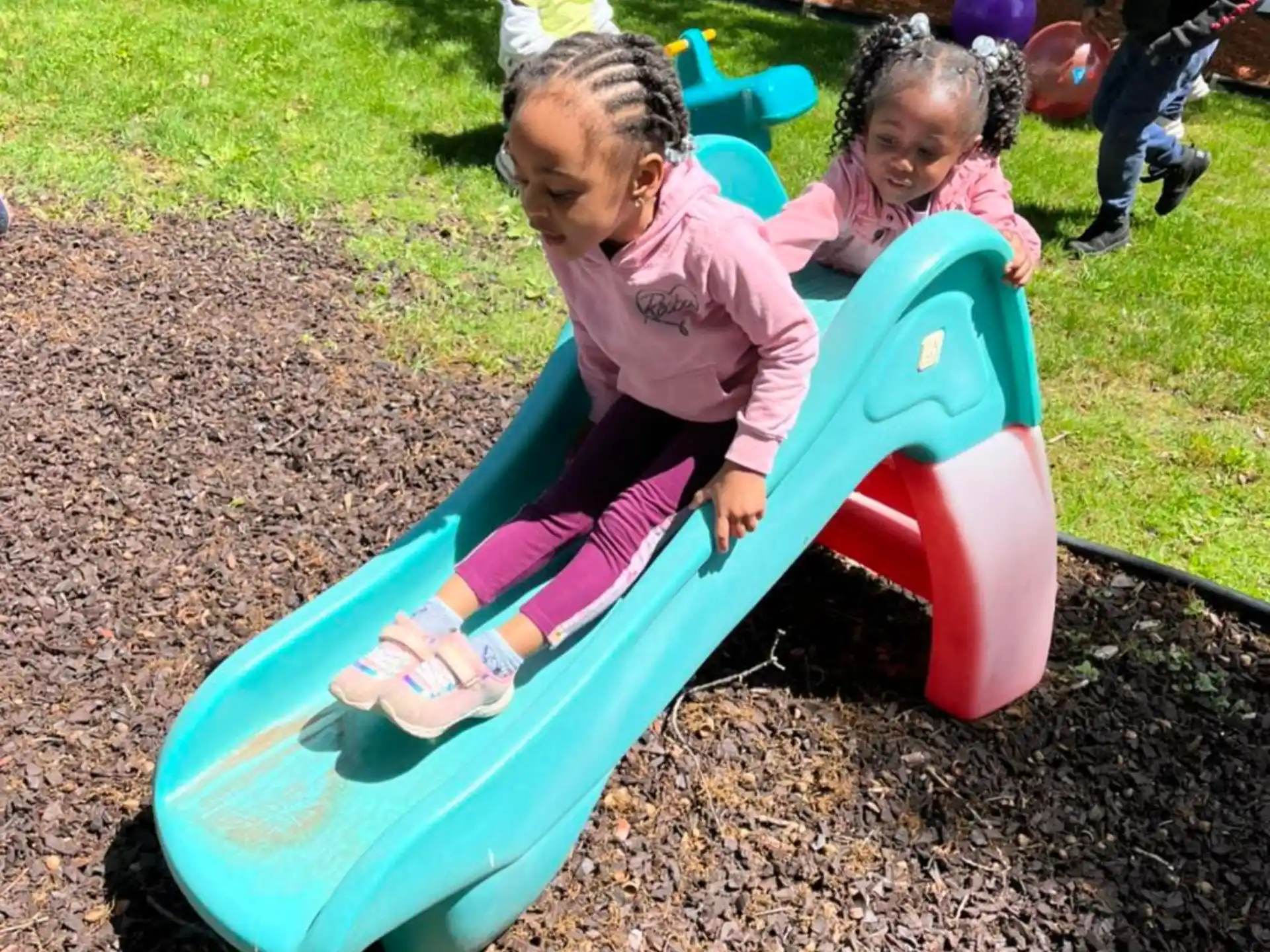 a group of children playing in a mud pit