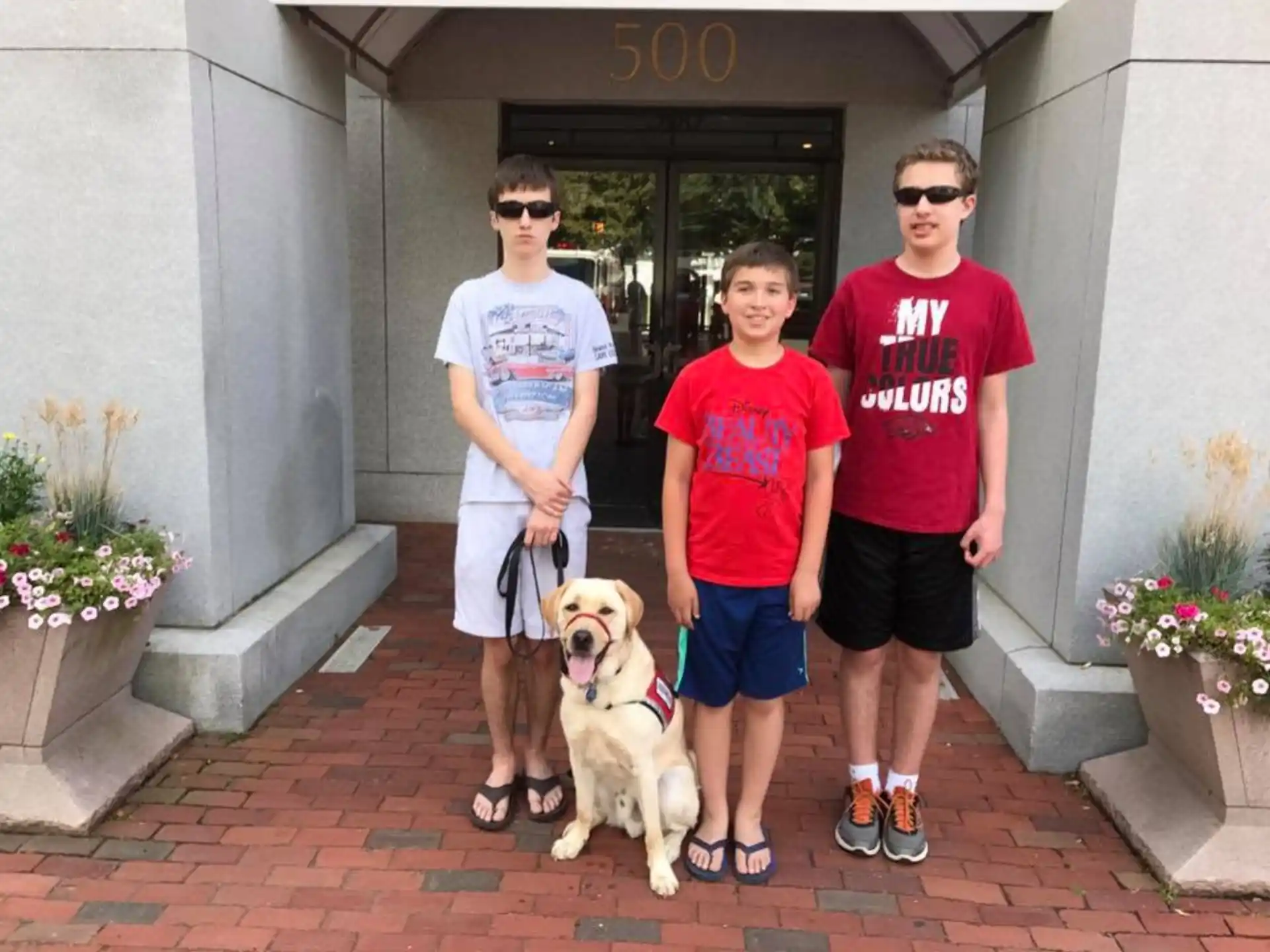 a group of people posing for a photo with a dog
