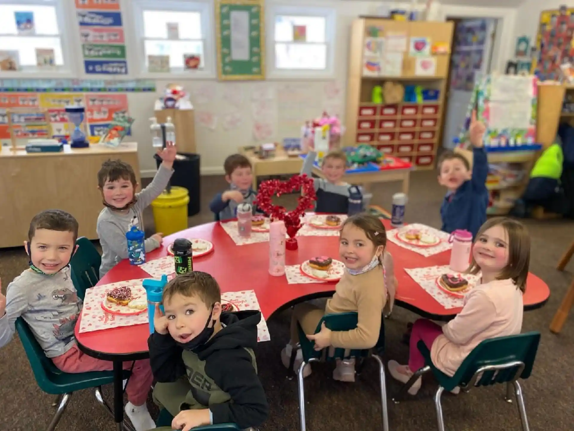 a group of children eating at a table