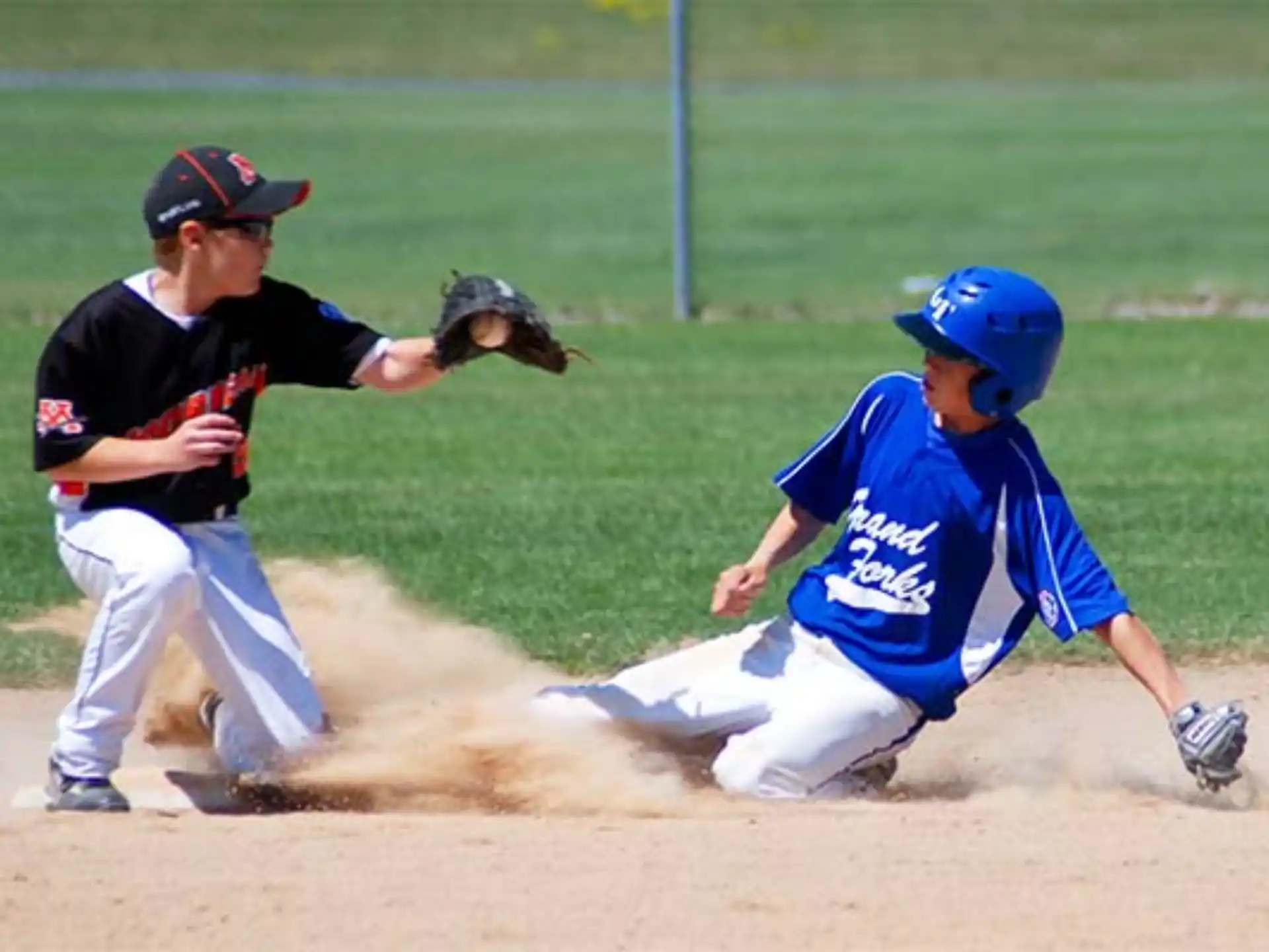 a couple of baseball players playing baseball