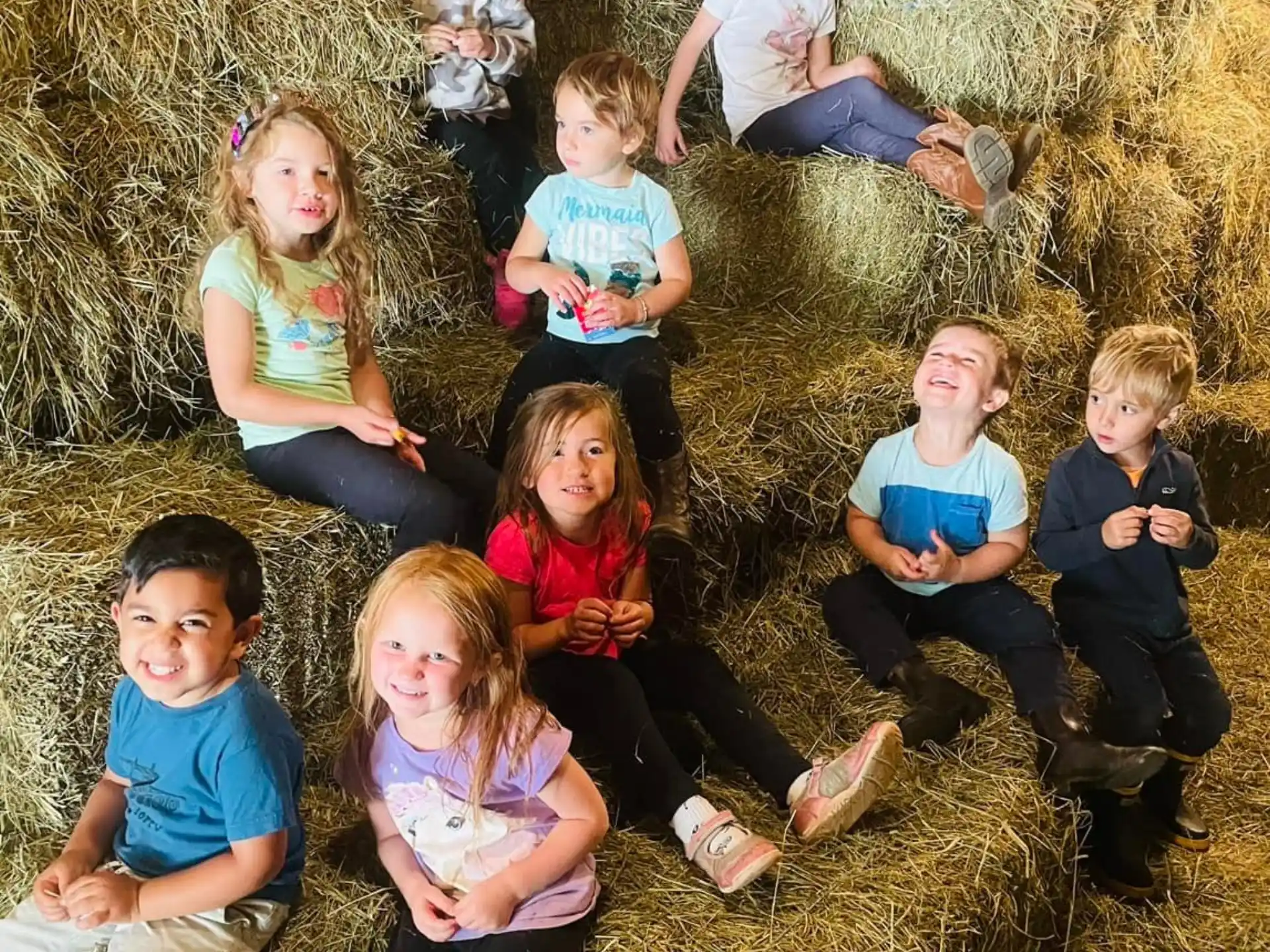 a group of children sitting on the ground
