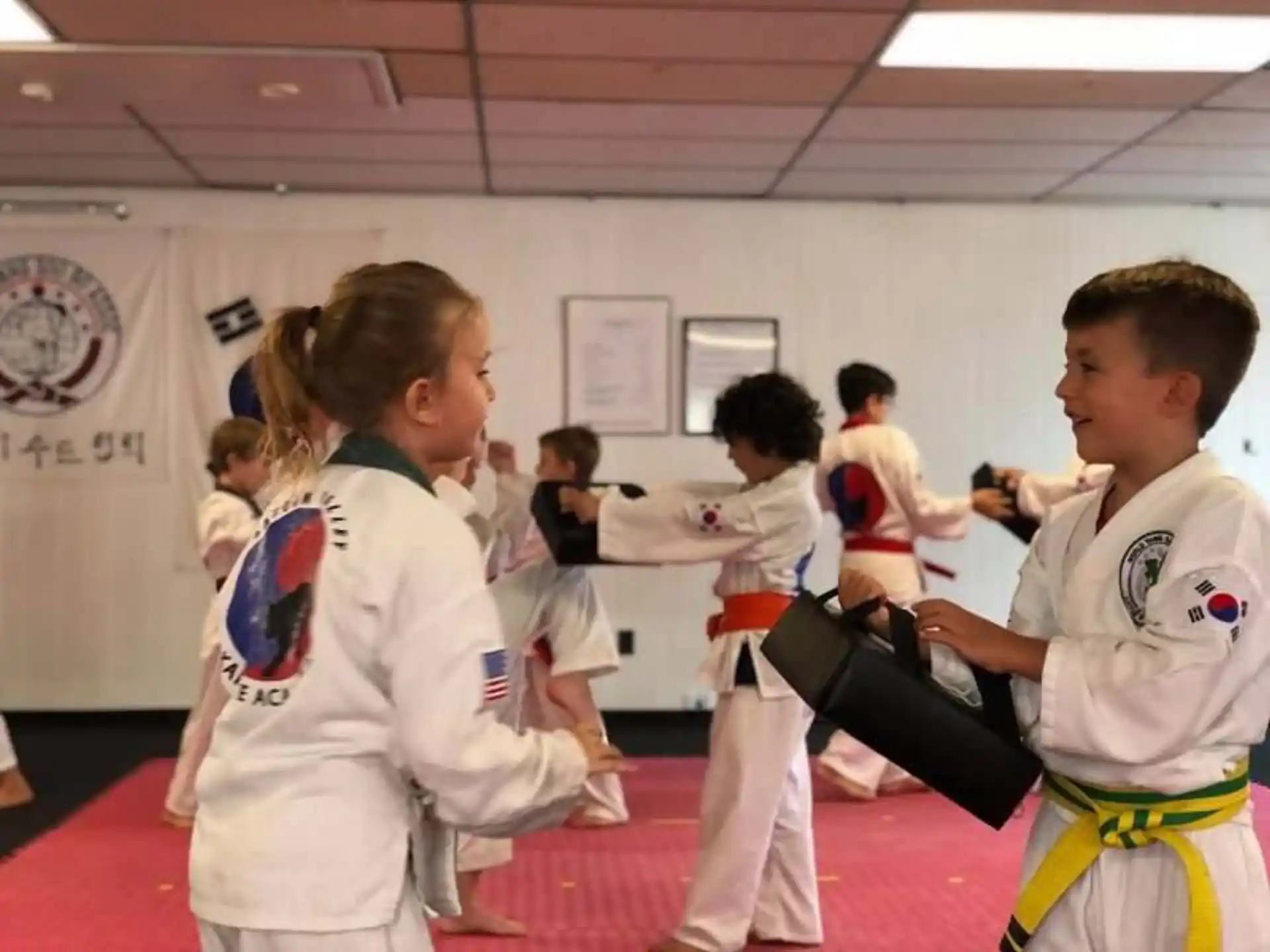 a group of children in karate uniforms