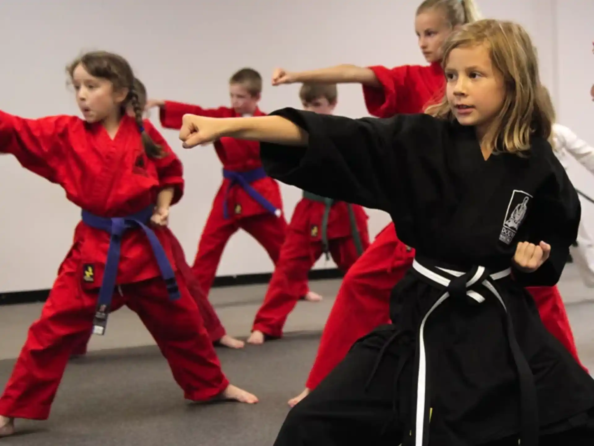 a group of people in red martial arts uniforms