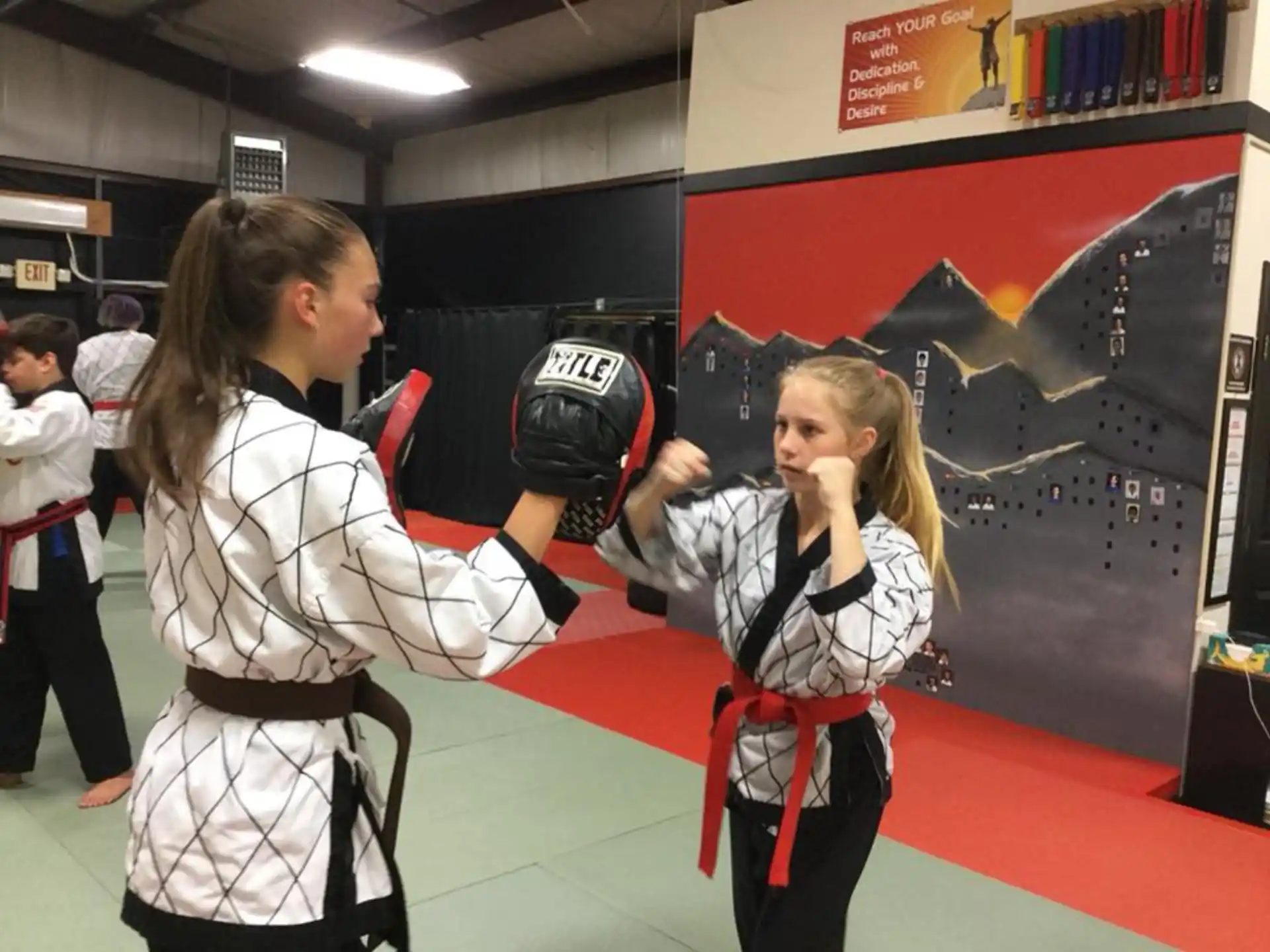 a couple of girls in karate uniforms