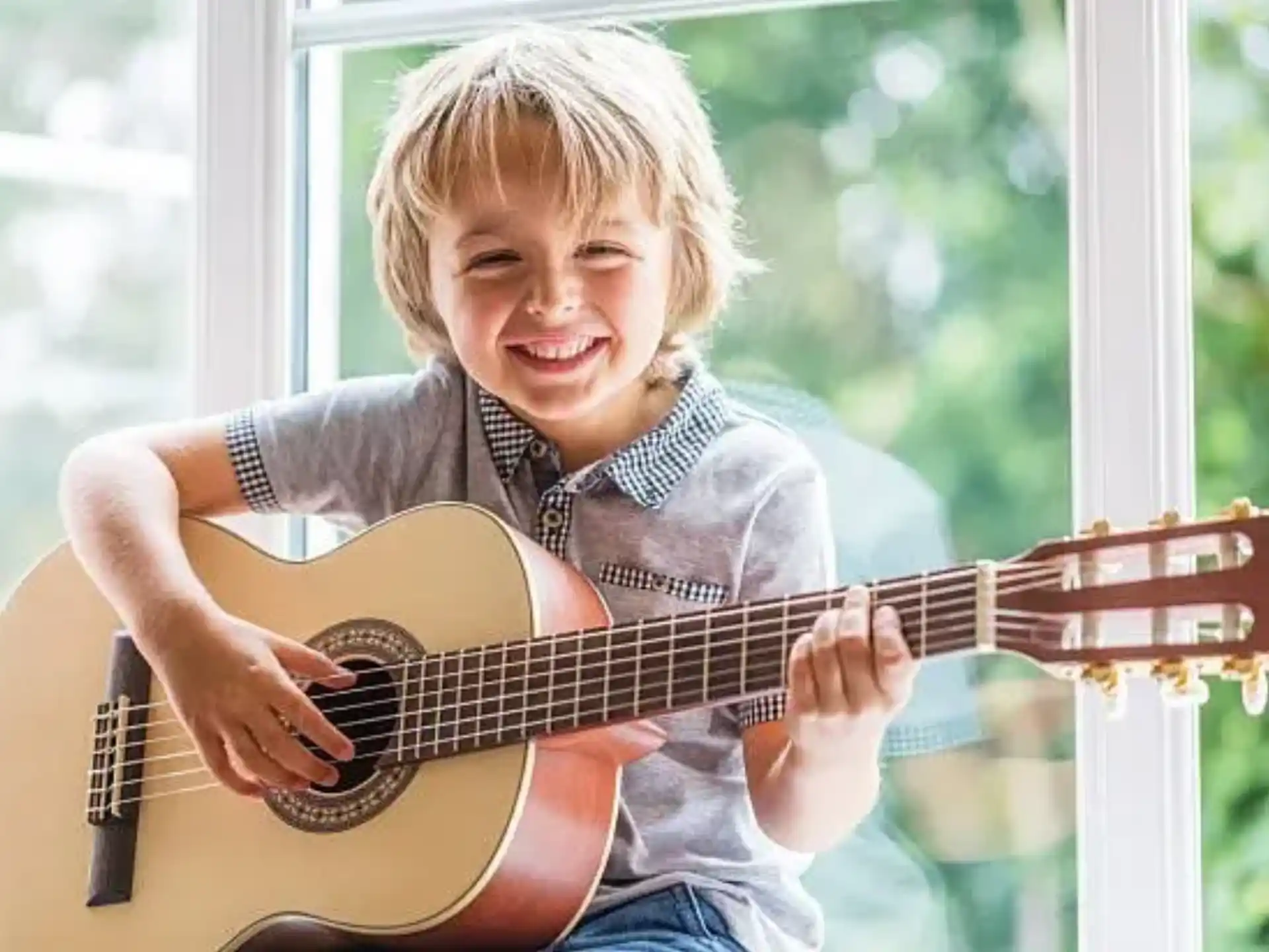 a boy playing a guitar