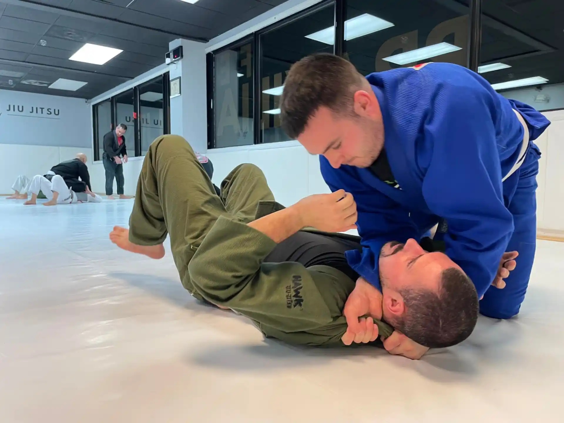 a man lying on the floor with another man lying on his back