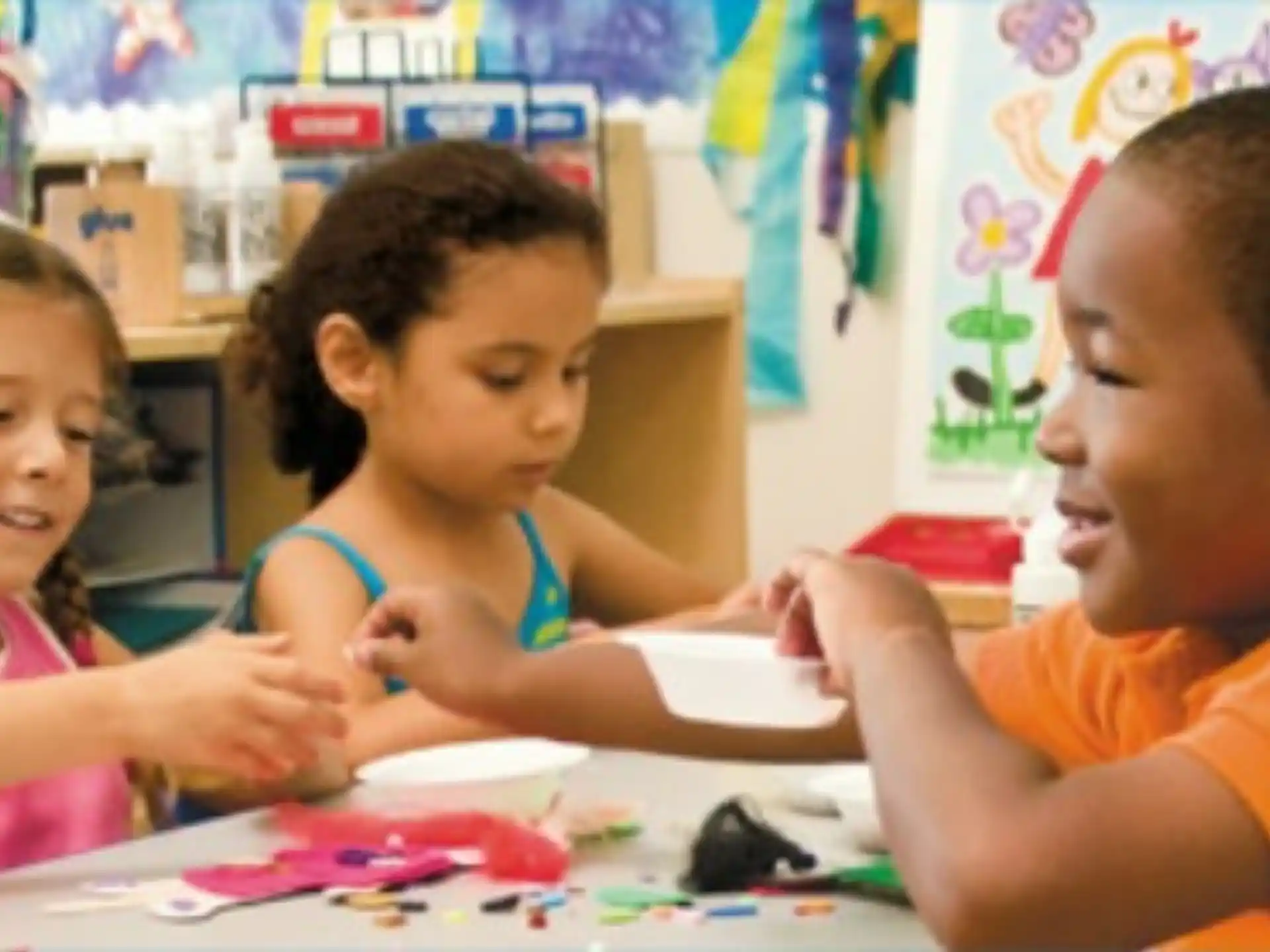 a few children sitting at a table