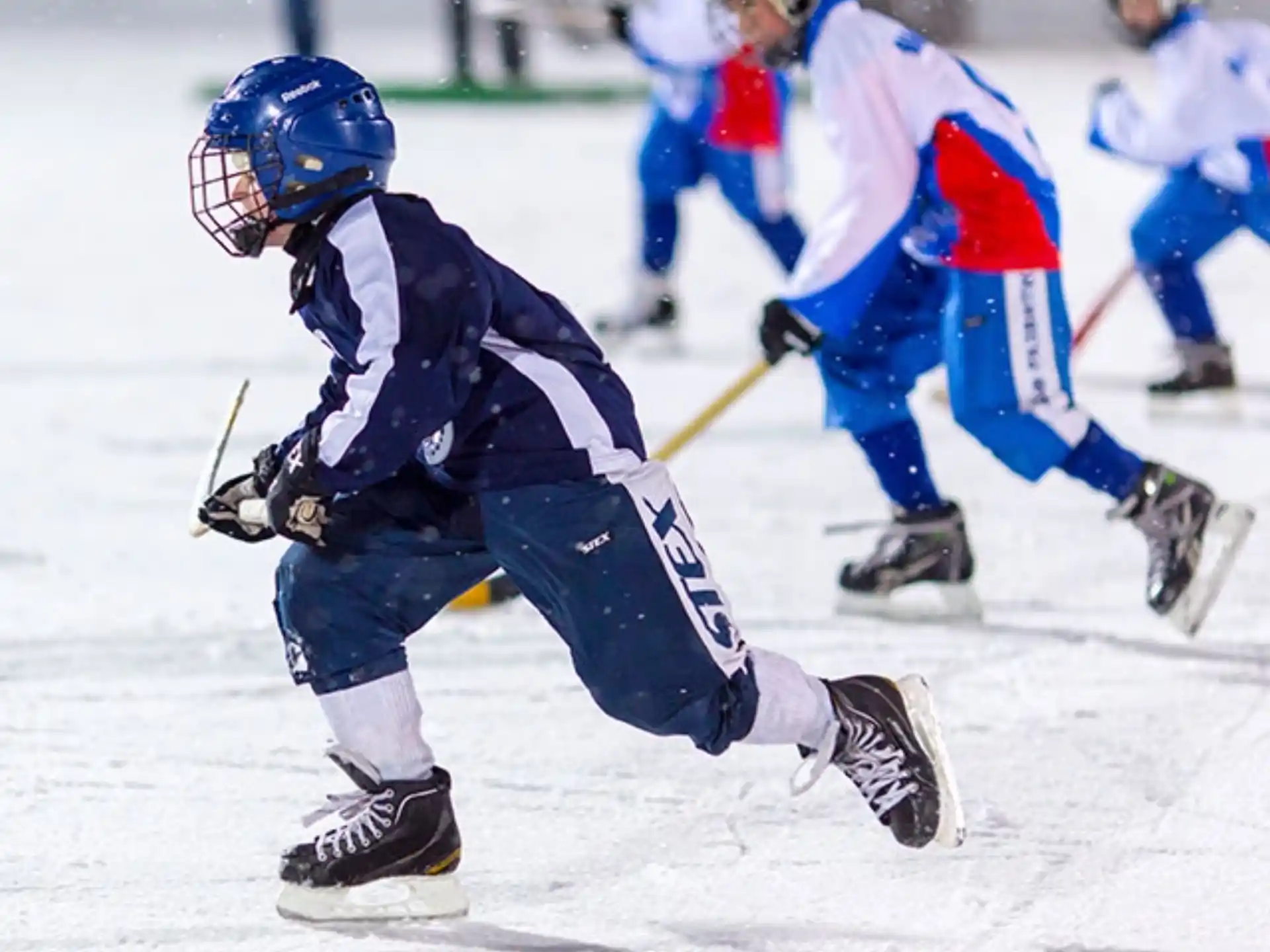 a group of people playing hockey
