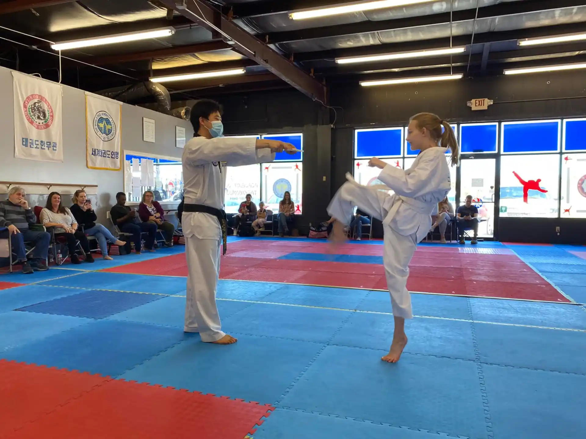 a man and a woman practicing martial arts