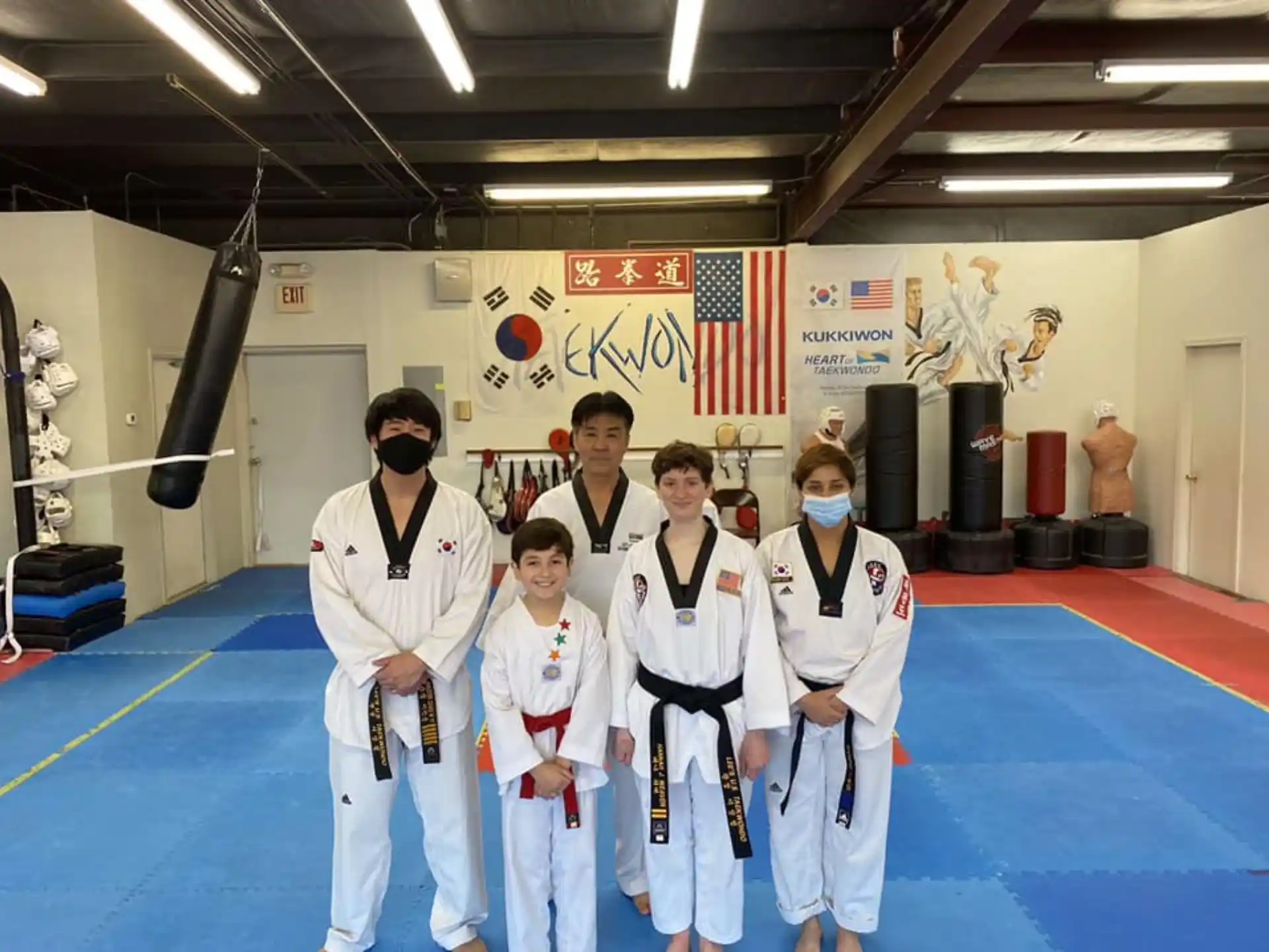 a group of people in white karate uniforms