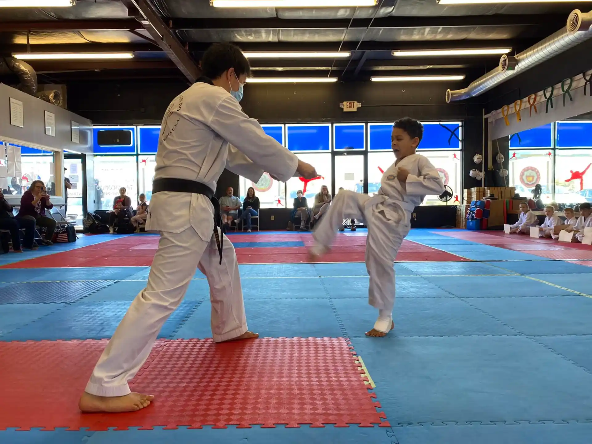 a person and a boy in karate uniforms