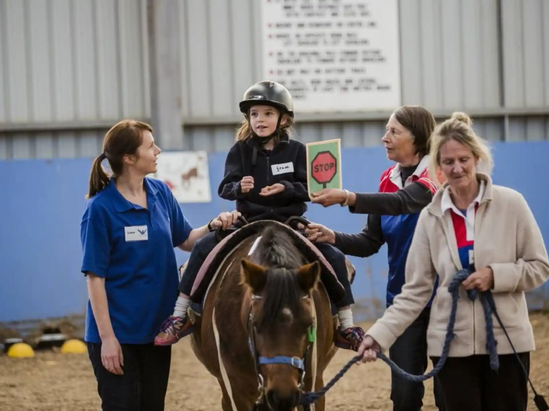 a group of women with a girl on a horse