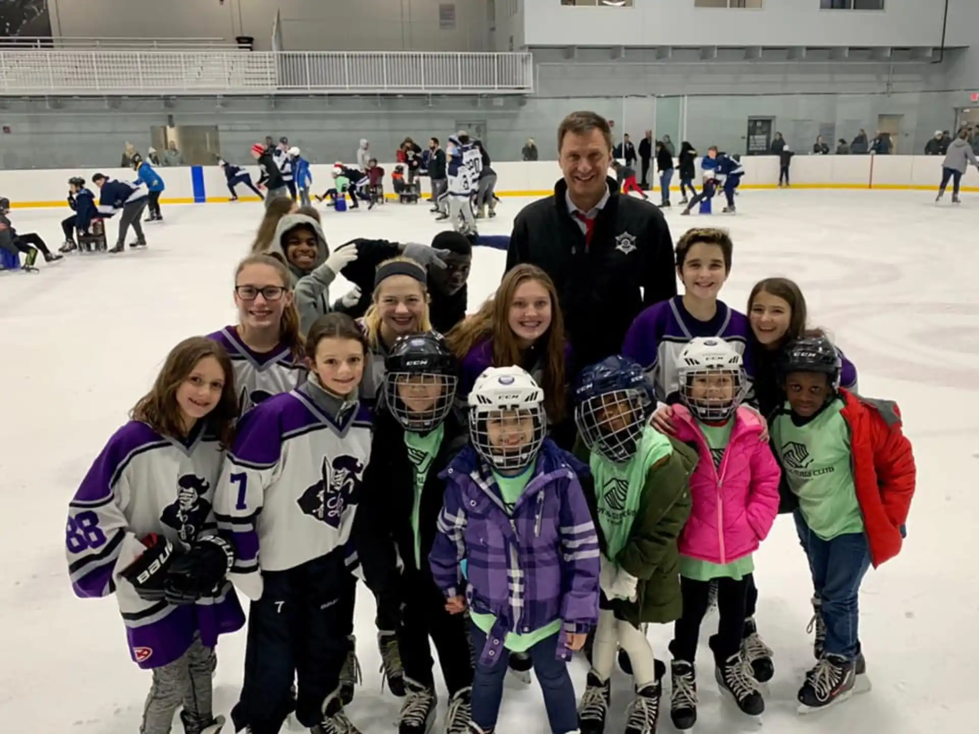 a group of people posing for a photo on an ice rink