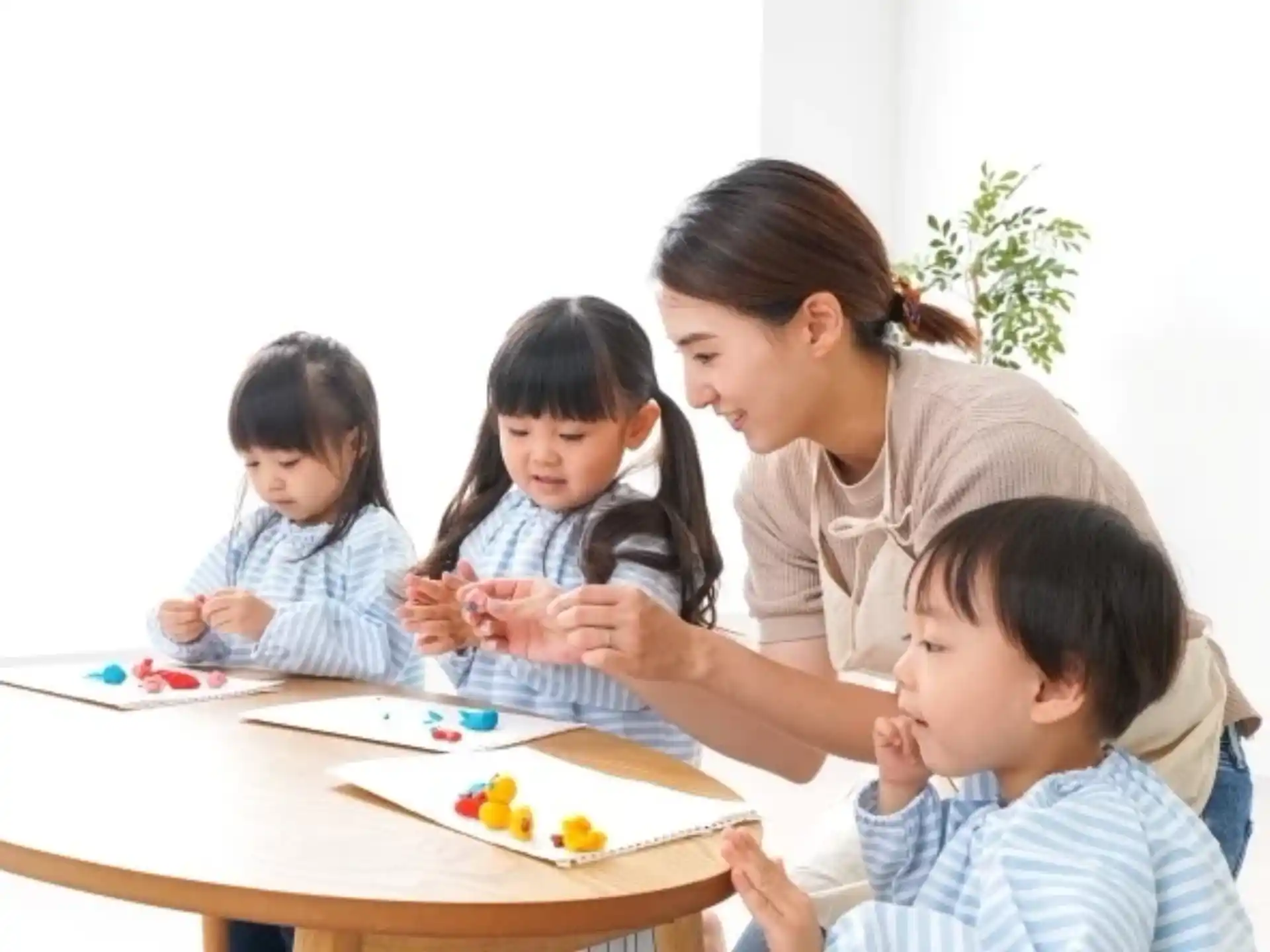 a person and several children sitting at a table