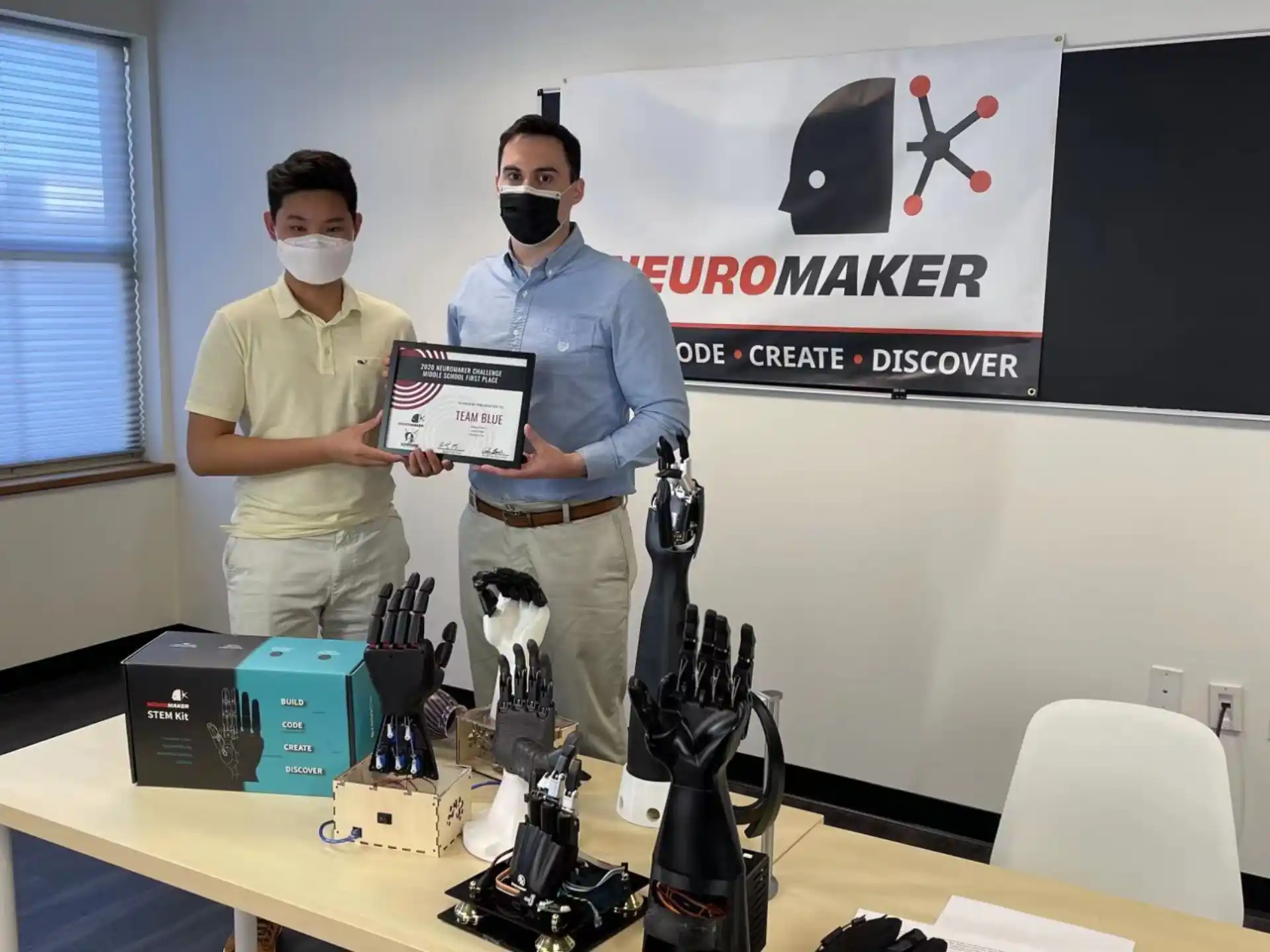 a couple of men wearing masks and holding a plaque