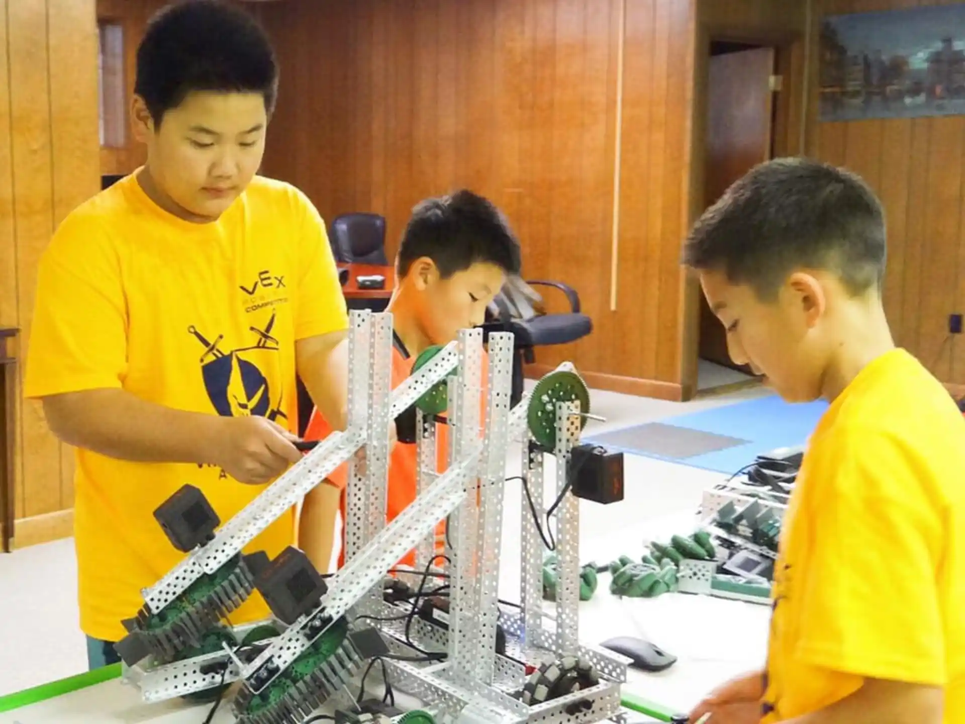 a group of boys working on a machine