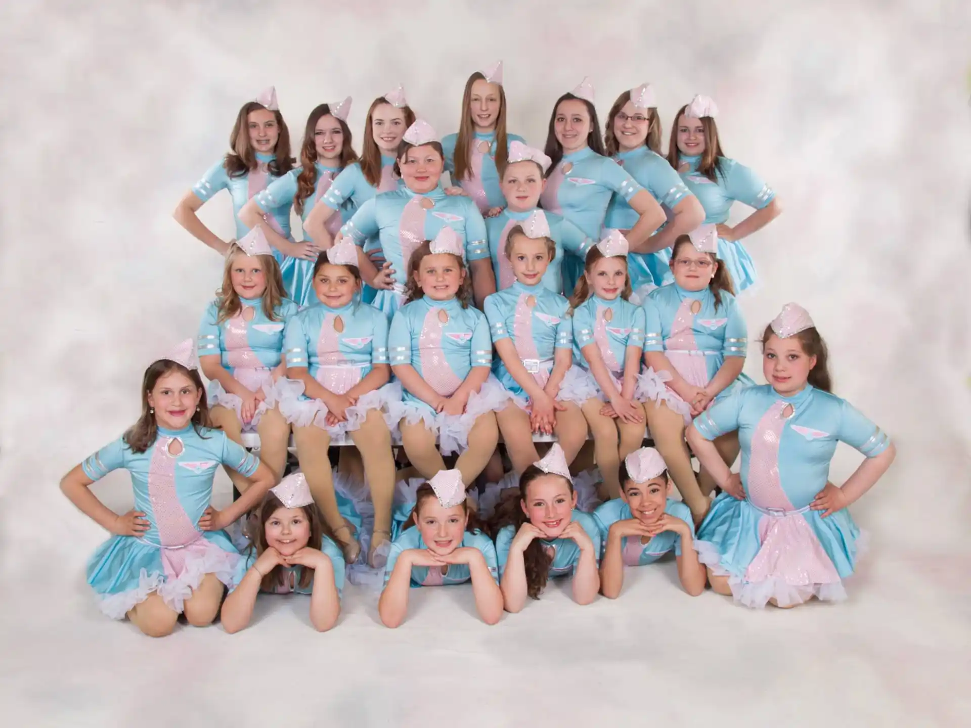a group of girls in blue dresses