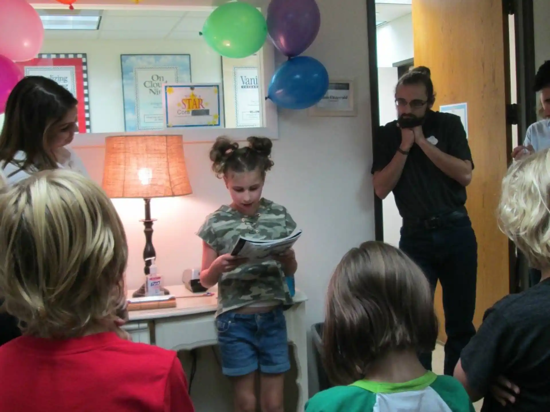 a group of people in a room with balloons