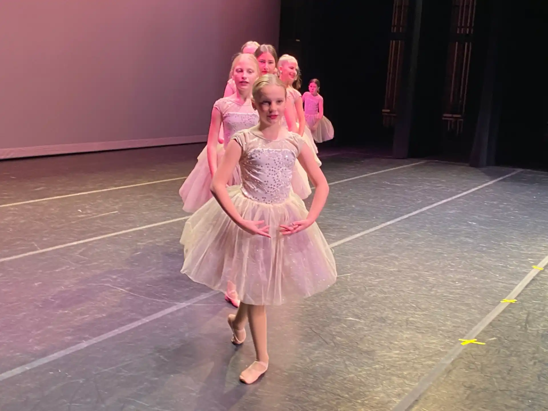 a group of women in dresses dancing