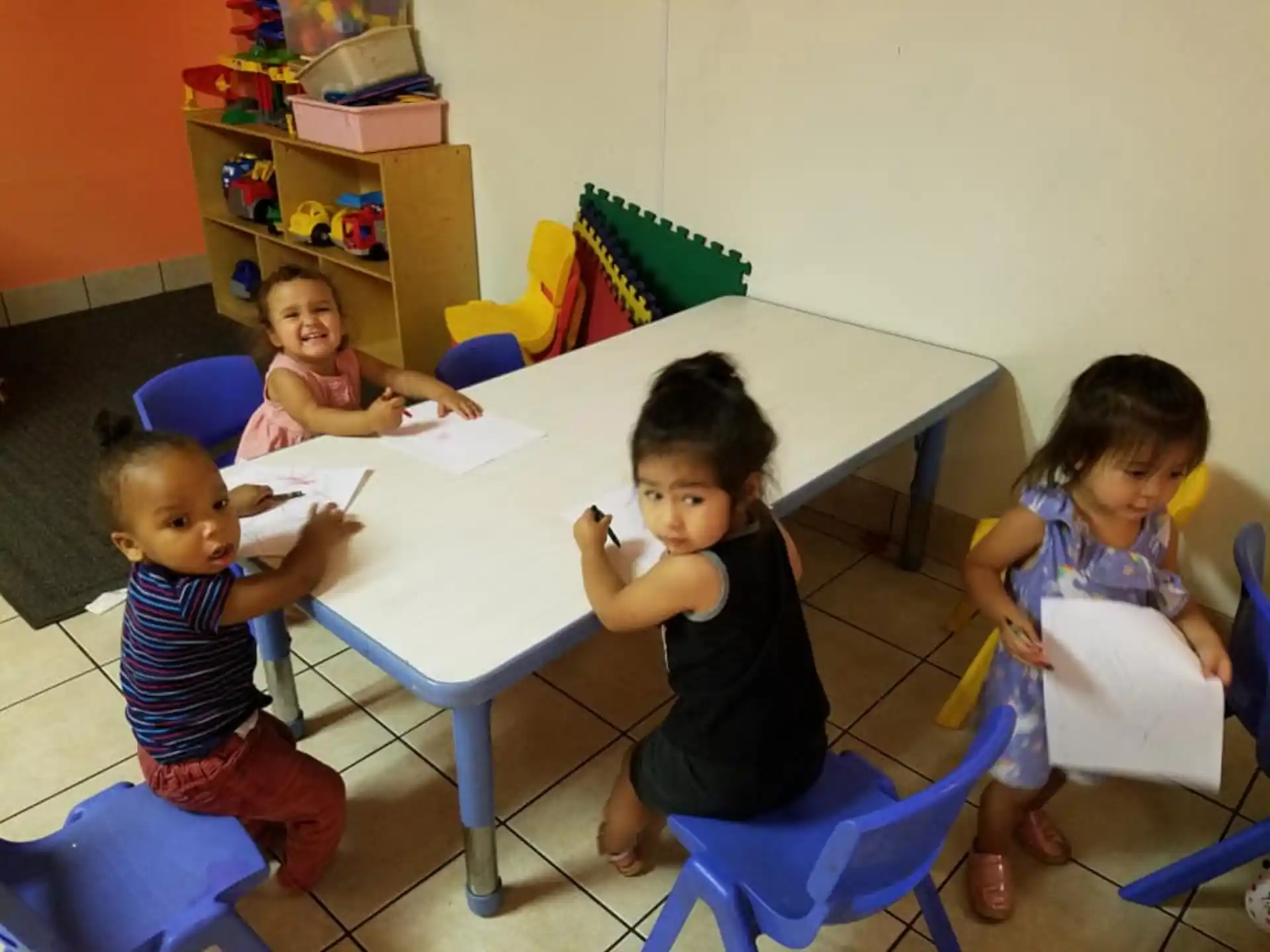 a group of children sitting around a table