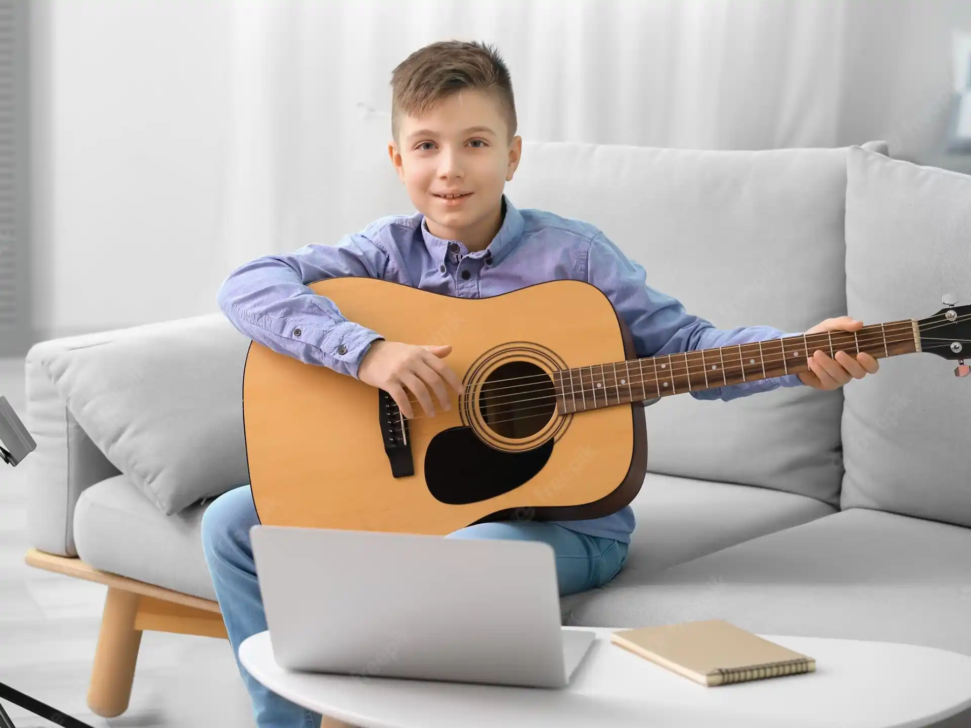 a boy playing a guitar