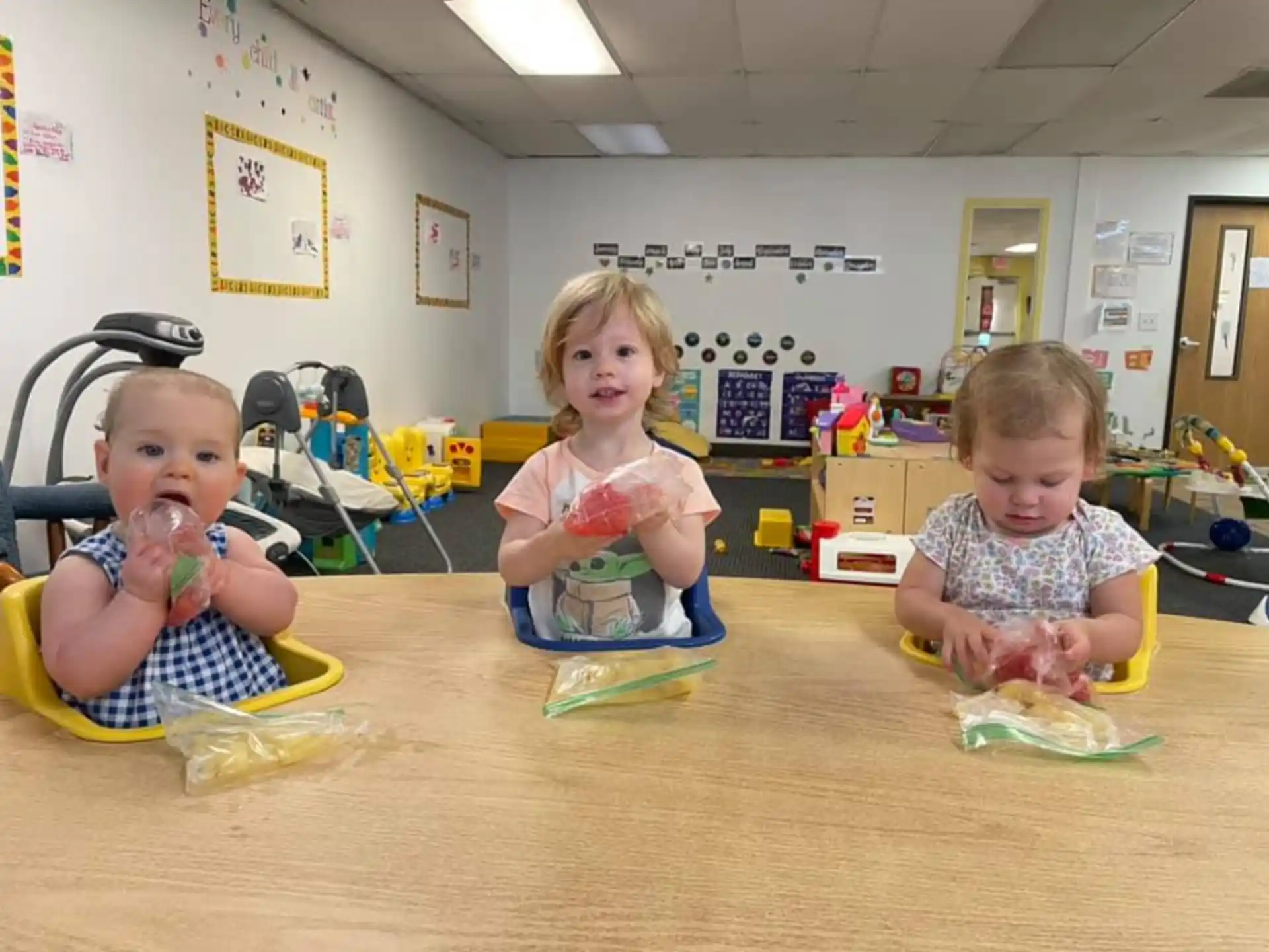 a group of children sitting on the floor eating food