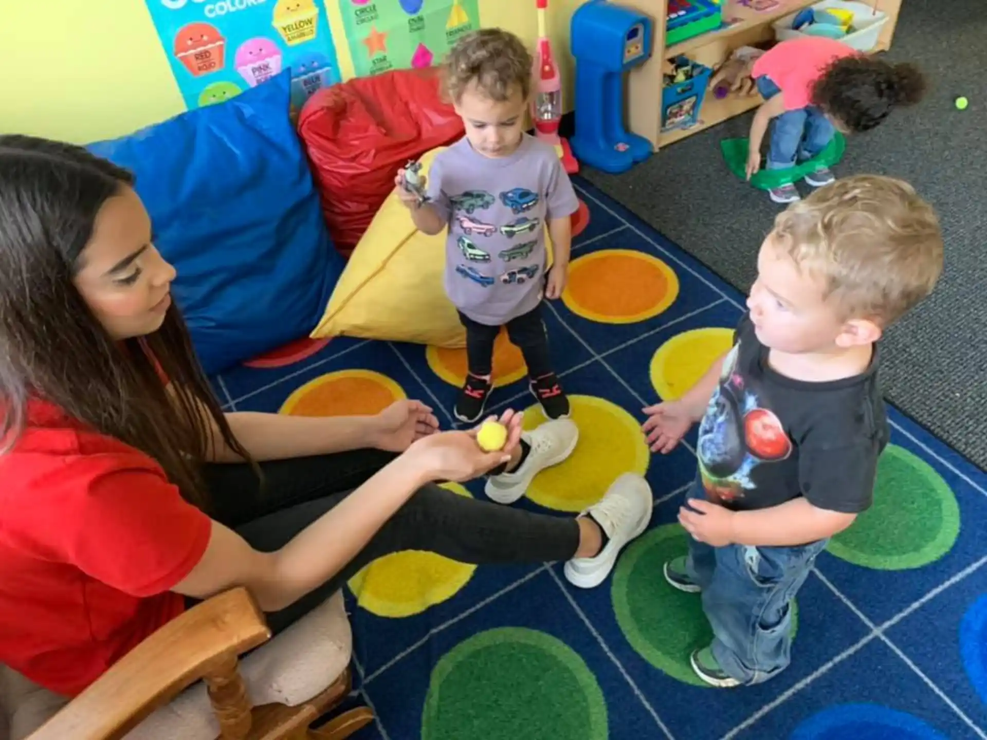 a person and kids playing with toys
