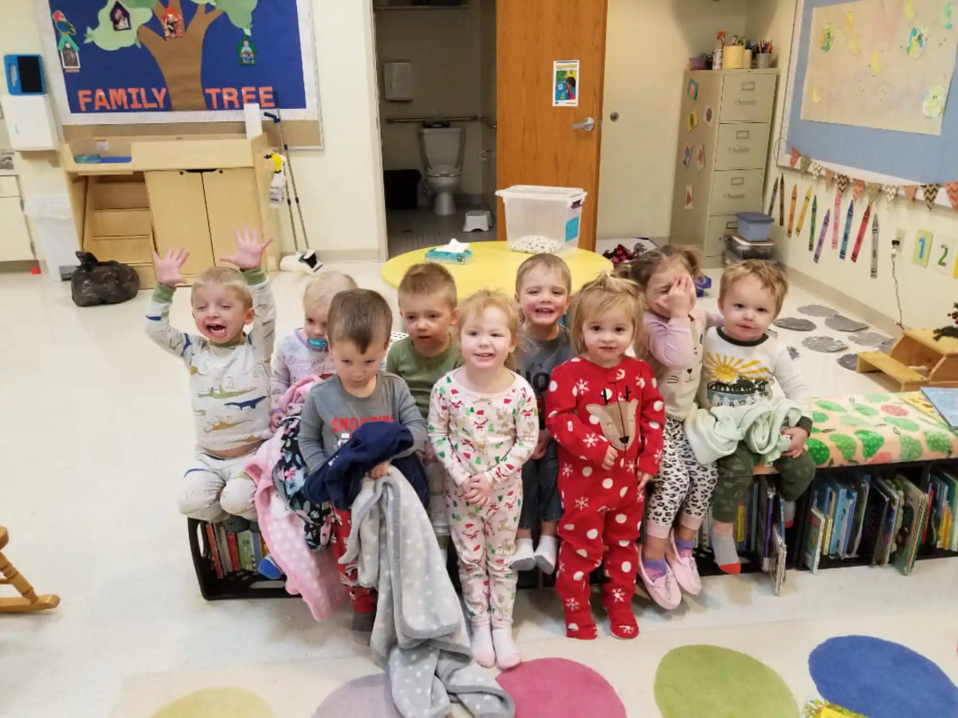 a group of children sitting on the floor in a classroom