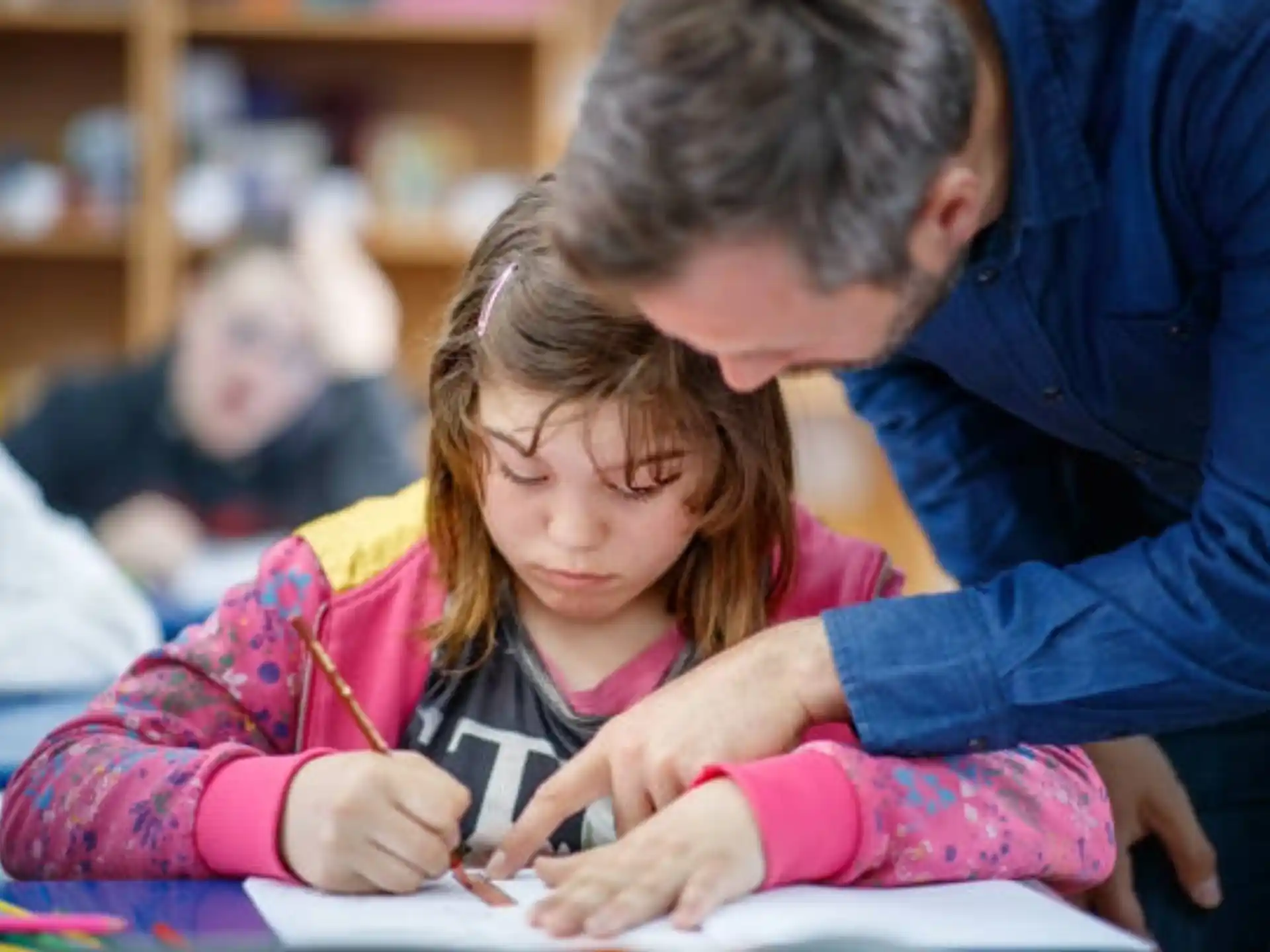 a person and a girl looking at a book