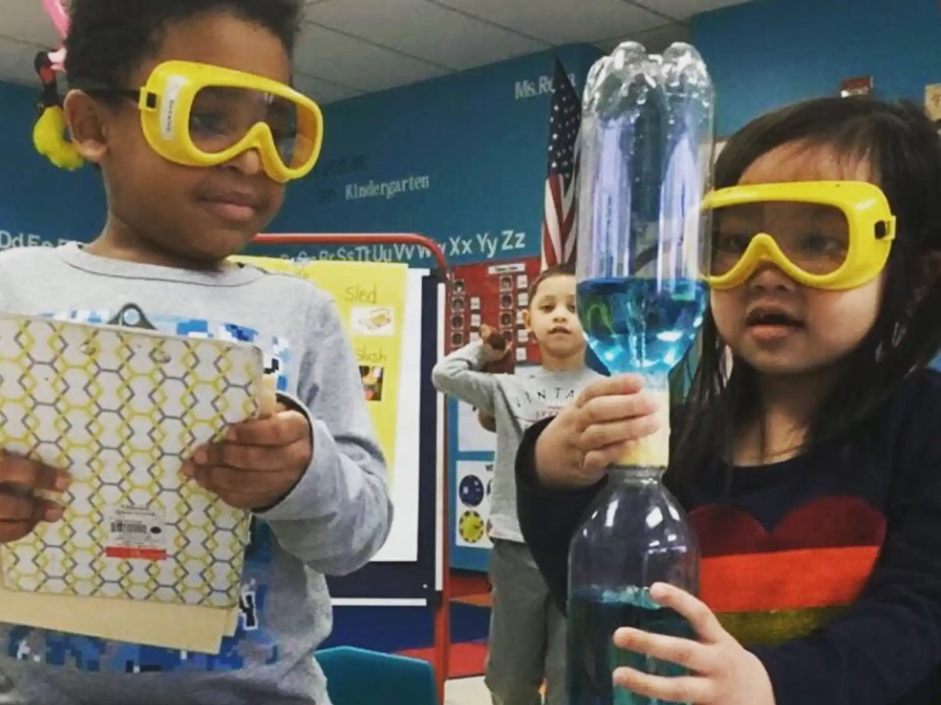 a group of kids wearing goggles and holding a bottle of water